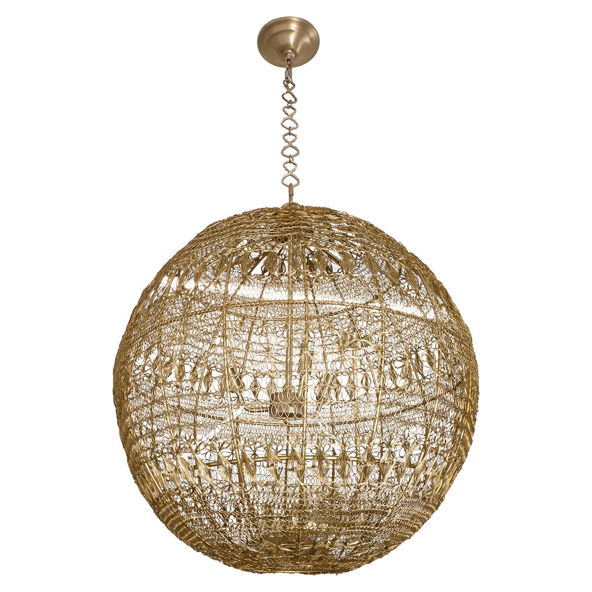 Monumental brass wire pendant with intricate wrought pattern including a flower motif.
