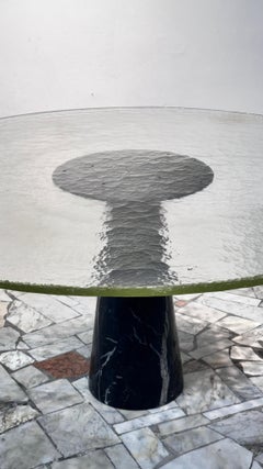 A monumental Italian dining table made of Murano glass and Nero McQueen marble.