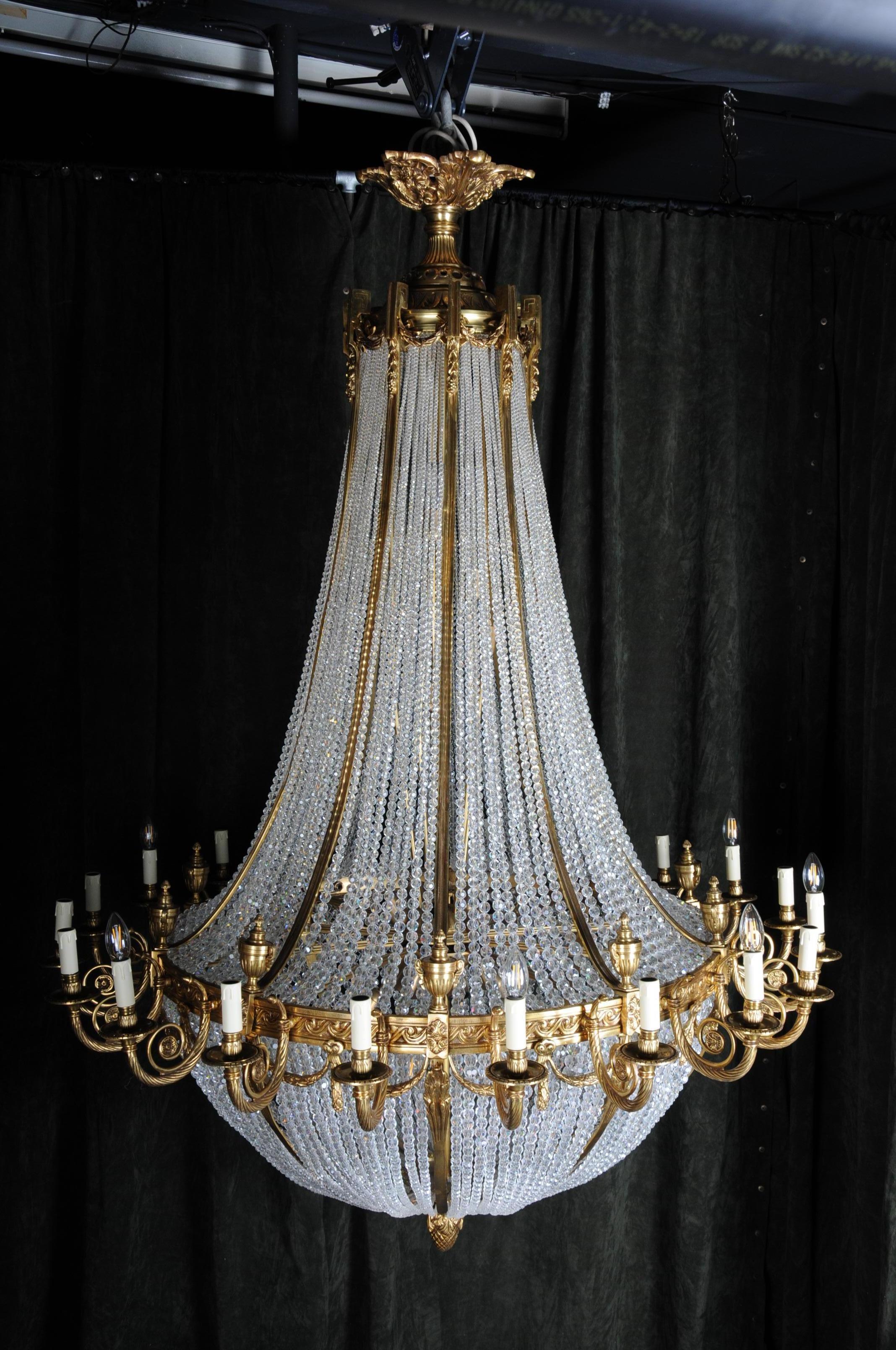 Monumental, noble ceiling chandelier in the Louis-Seize style

Engraved Bronze. Connected through ornamental, reliefed
hoop. Basket-formed corpus from hand-cut frenches ball prisms. Connected through wide, ornamental reliefed and broken hoops. There