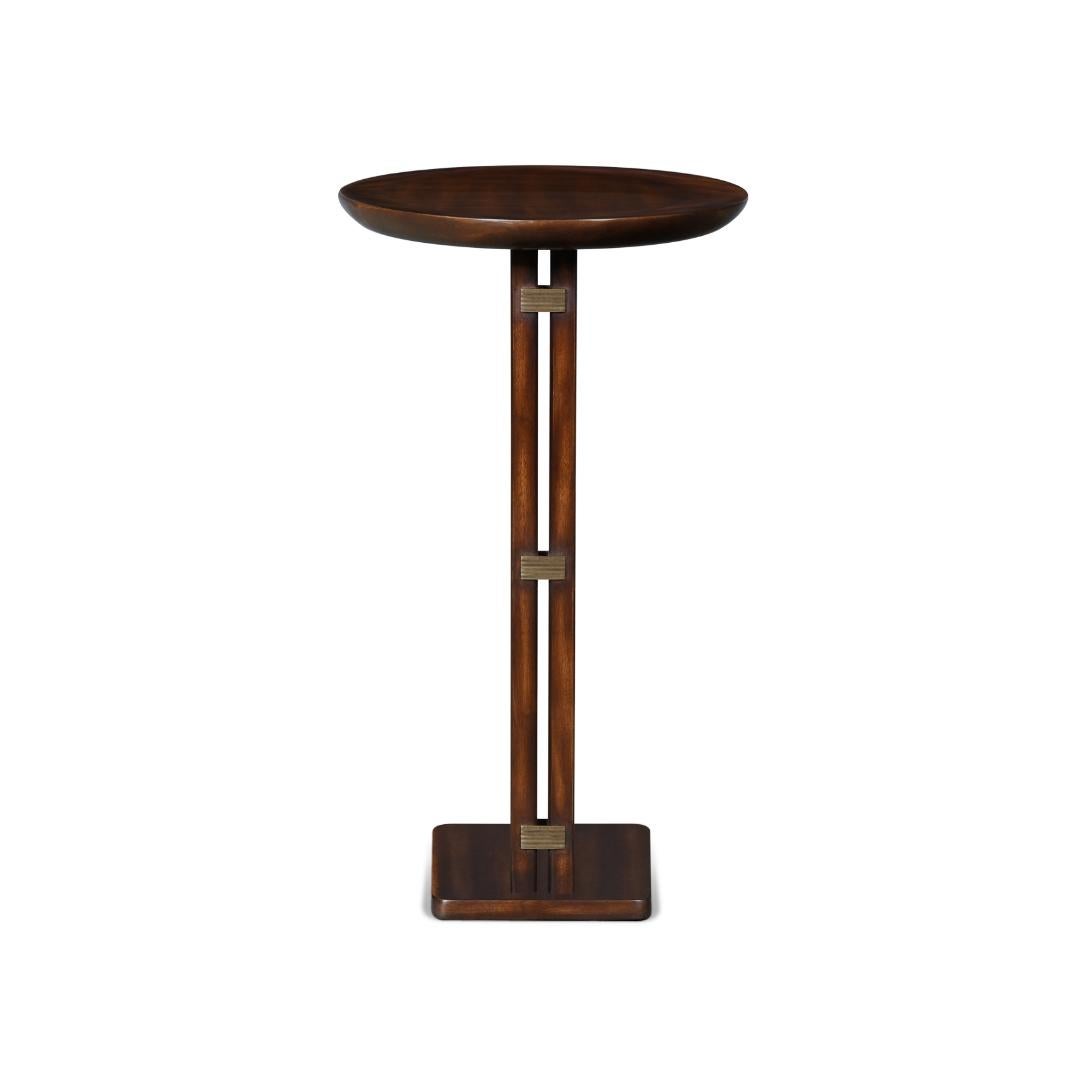 This side table has simple but detailed design. It has a brass inlay on the stand, an oval table top, a rectangular base, and three brass staples on the spine. It is perfect for livingrooms or as a side table anywhere. It can also be made in