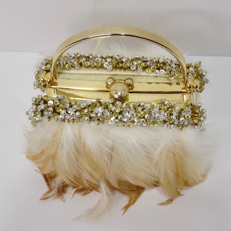 Do not miss out on this whimsical vintage feather embellished minaudiere! This breath taking novelty clutch features a plethora of feathers that fade in a gorgeous gradient from ivory to warm brown. The feathers are beautifully complimented by an