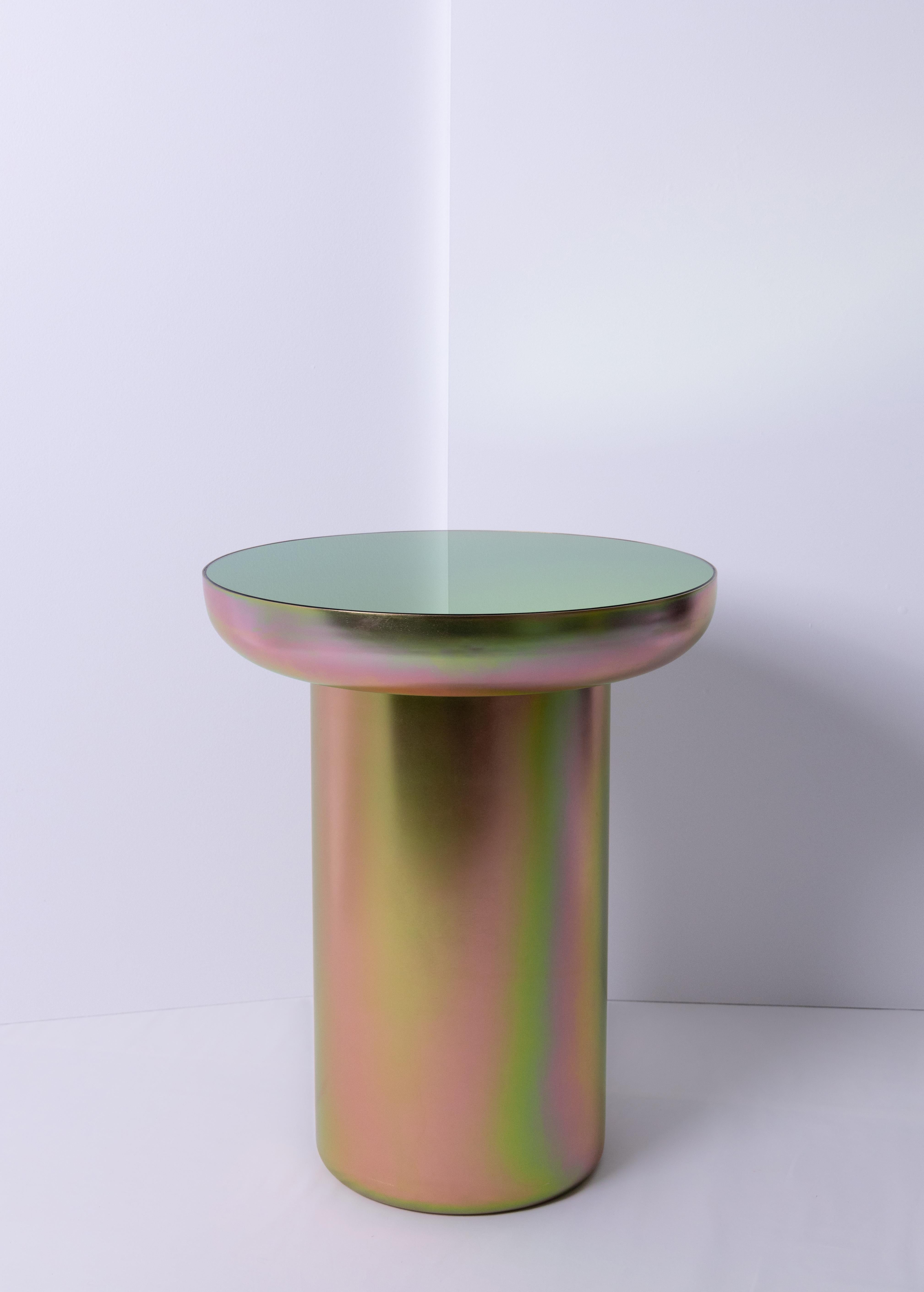 Mood side zinc is a visually light sculpturally strong table coated in a finish that elevates form and celebrates color. The base is plated in a Zinc coating, a performative finish which allows the piece to reflect the colors and tones of its