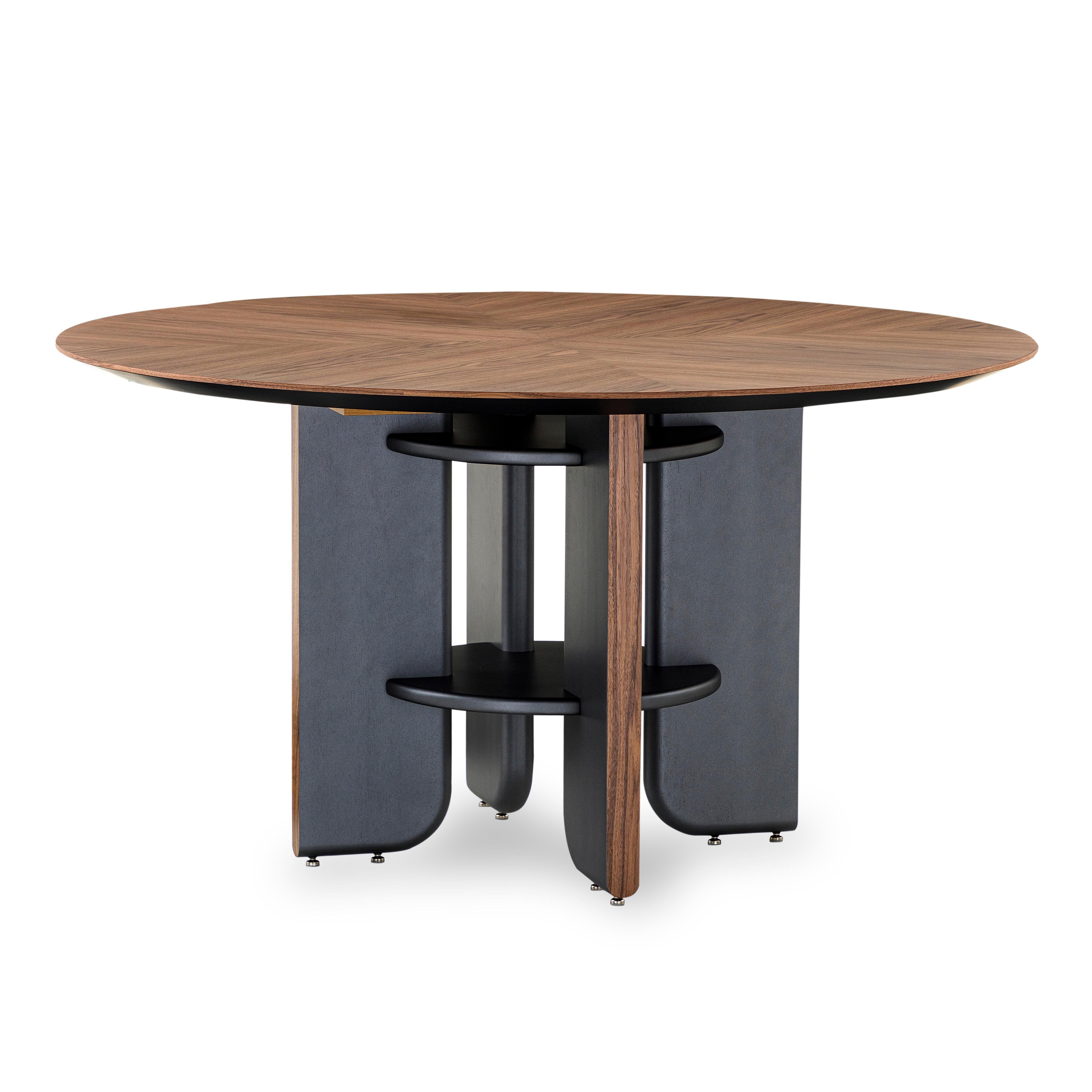 This round dining table in a walnut veneered top finish with black wood legs is the perfect table for your house. Every dining space needs a good dining table and the Moon round table is going to be perfect for that space, with an exclusive design
