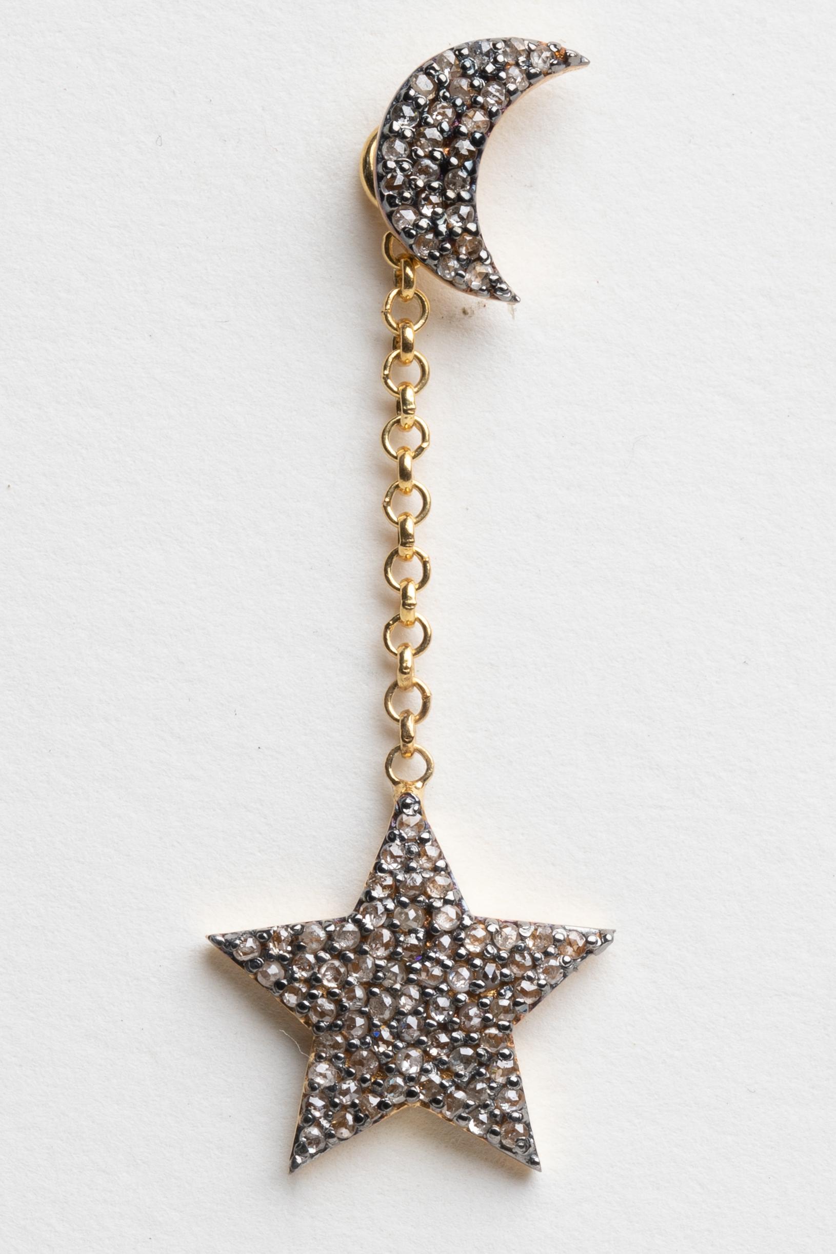 A pair of dangle earrings with round brilliant cut diamond crescent moons as the post and diamond stars dangling from a gold chain.  18K gold post for pierced ears.  The chain with the star can be removed if you just wanted to wear the studs.