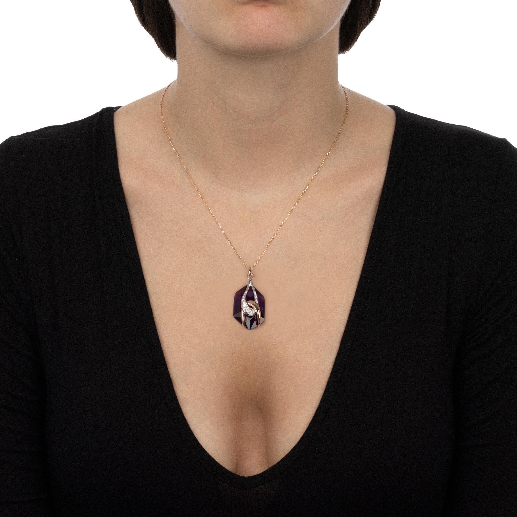A handmade contemporary jewellery piece with a modern design, this pendant necklace is a dazzling fashion statement. The evocative charm of the central amethyst blends with the innovative design of the intertwined decoration blends with the embrace
