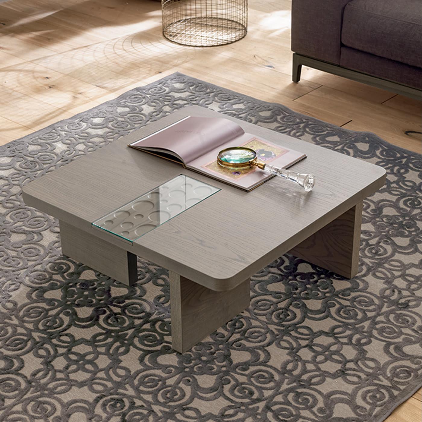 Inspired by marble working techniques, the Moon Coffee Table feature a panel with circular carvings, covered by a panel of transparent glass. The table is crafted in ash wood and coated with the finishing of your choosing, shown here in Modo10's