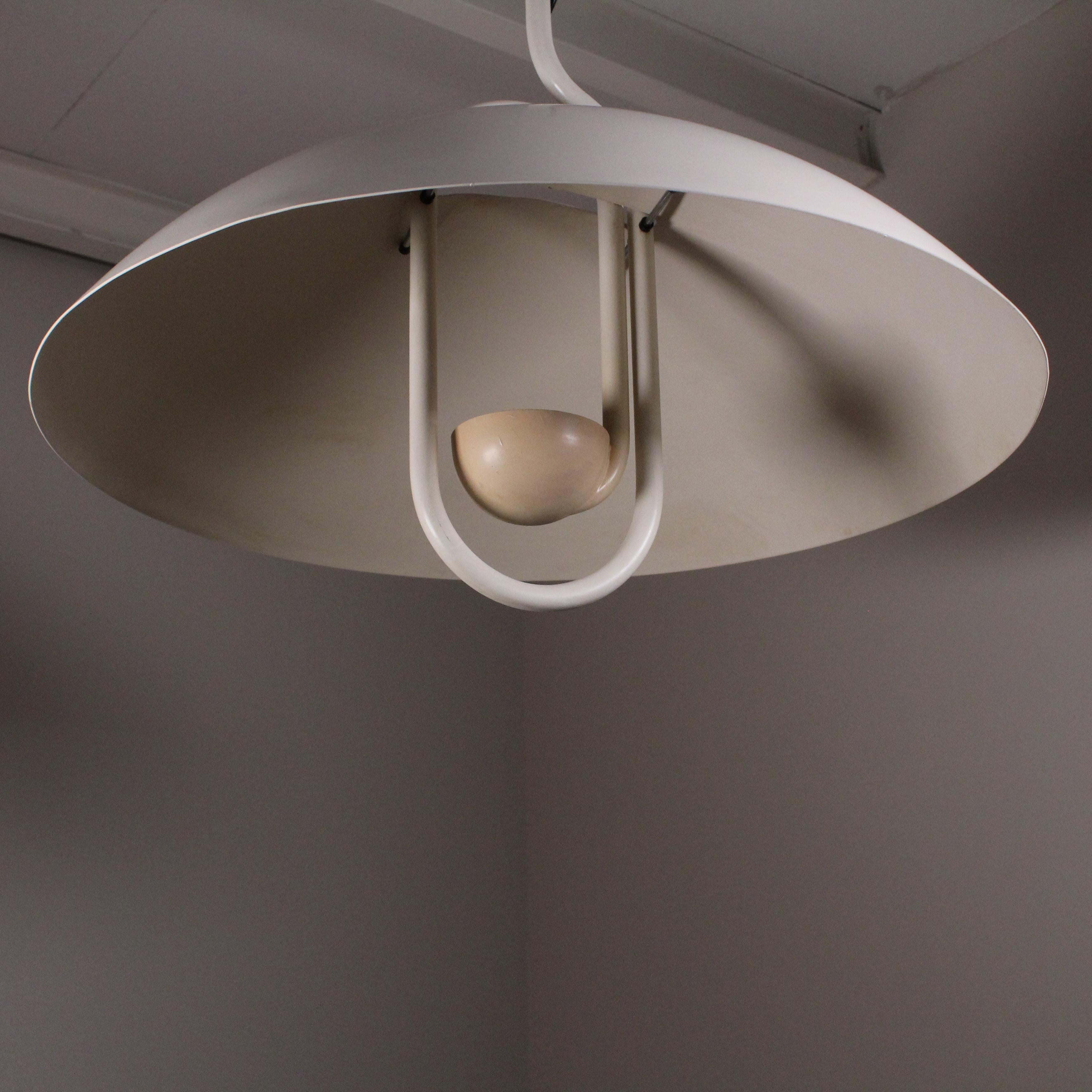 The Moon Dome is a large metal dome pendant lamp of Italian design. Manufactured by Martinelli Luce, Italy in the 1980s, it has an adjustable mechanism that allows it to rise and fall by moving a ball-shaped weight hanging from a metal cable. The