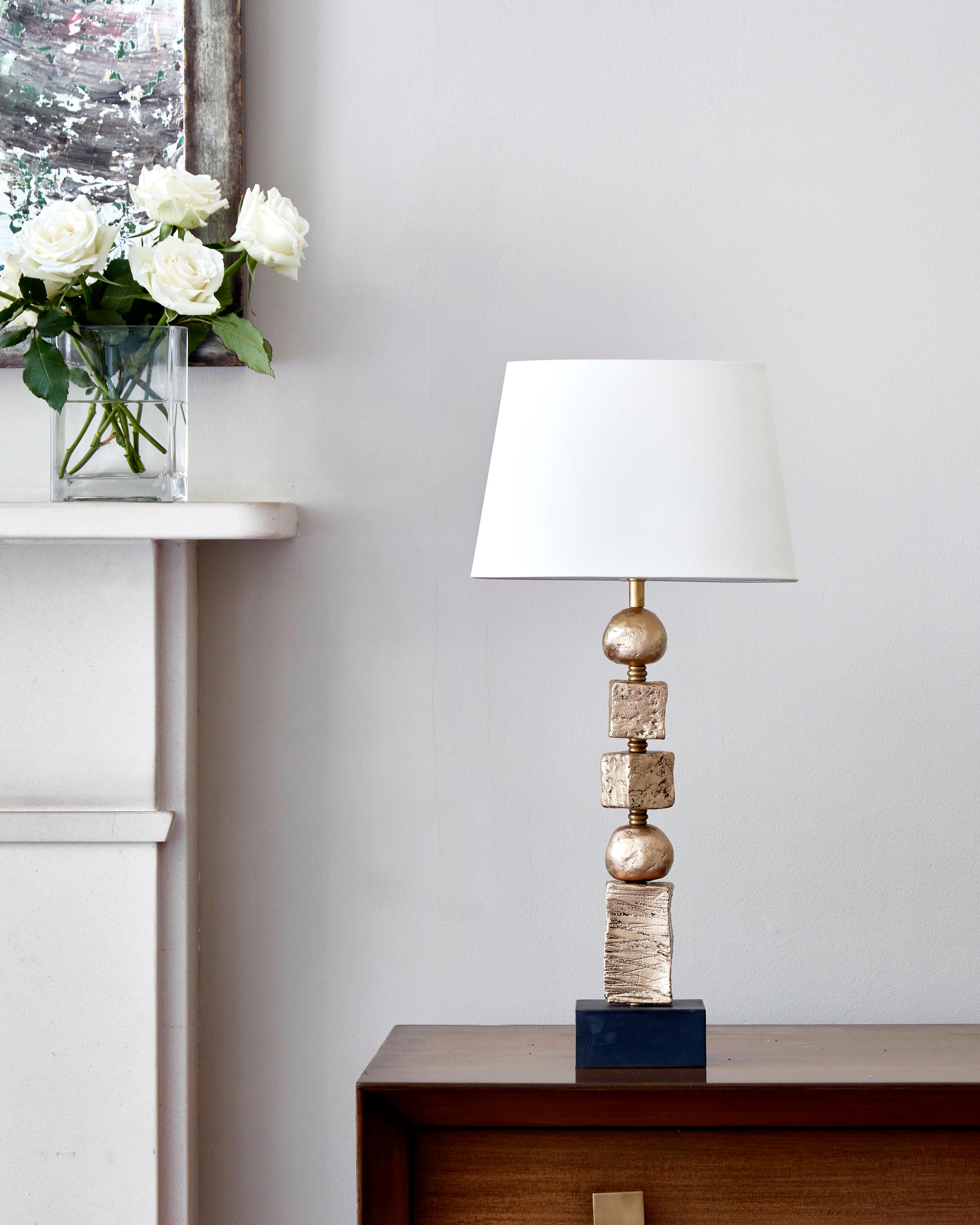 This contemporary Margit Wittig table lamp from the new Moon Gold Collection sits on a slate square base and includes gold leafed components. The sculpted elements are signature of Margit Wittig's work. The materials Wittig chose for this unique