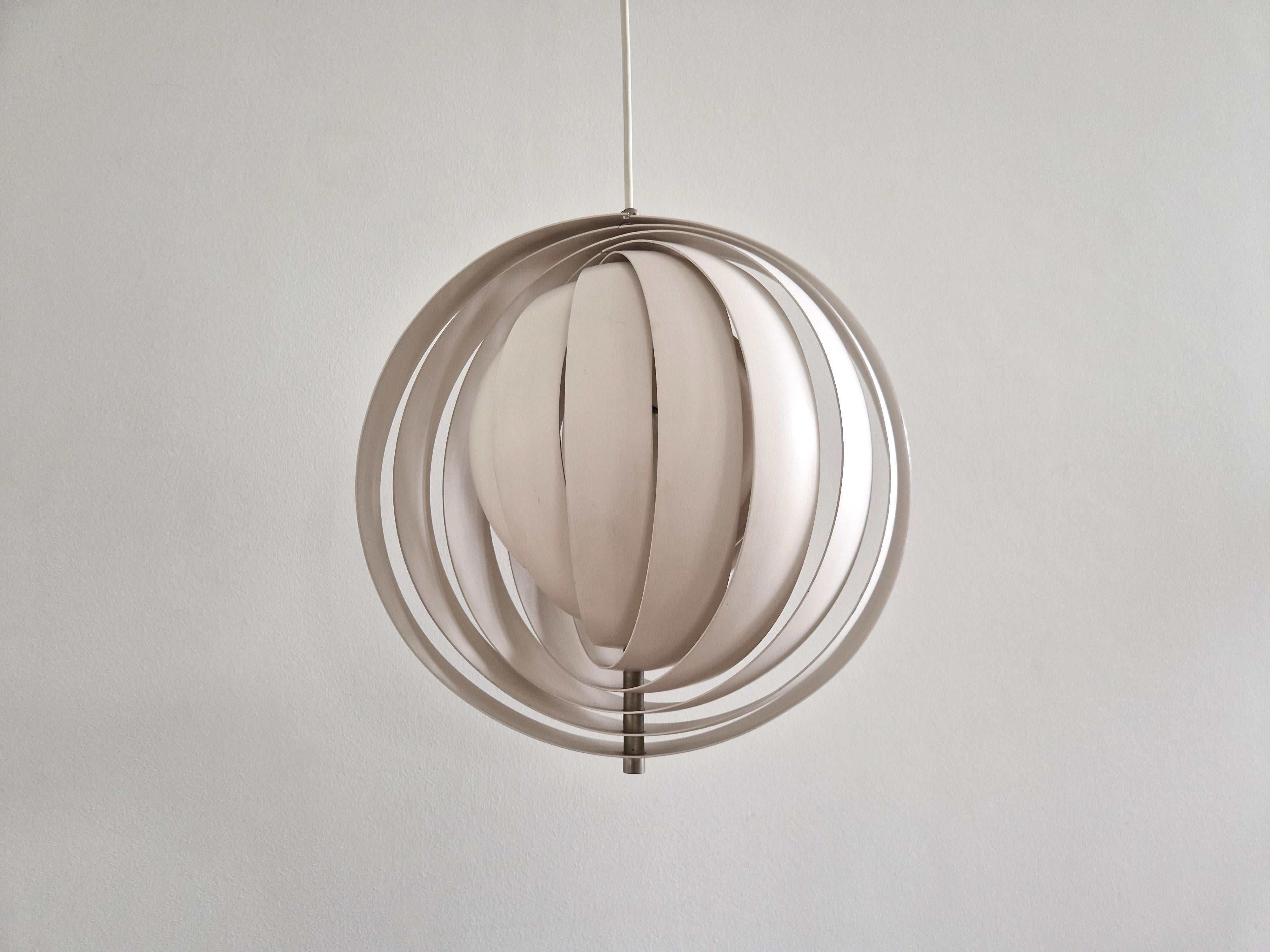 This is an early version of the 'Moon lamp' (in the USA 'Visor') by Verner Panton for Louis Poulsen. A design from the 1960's and still an eye-catcher today. An exceptional light that gives a great light to a room as the light gets diffused by the