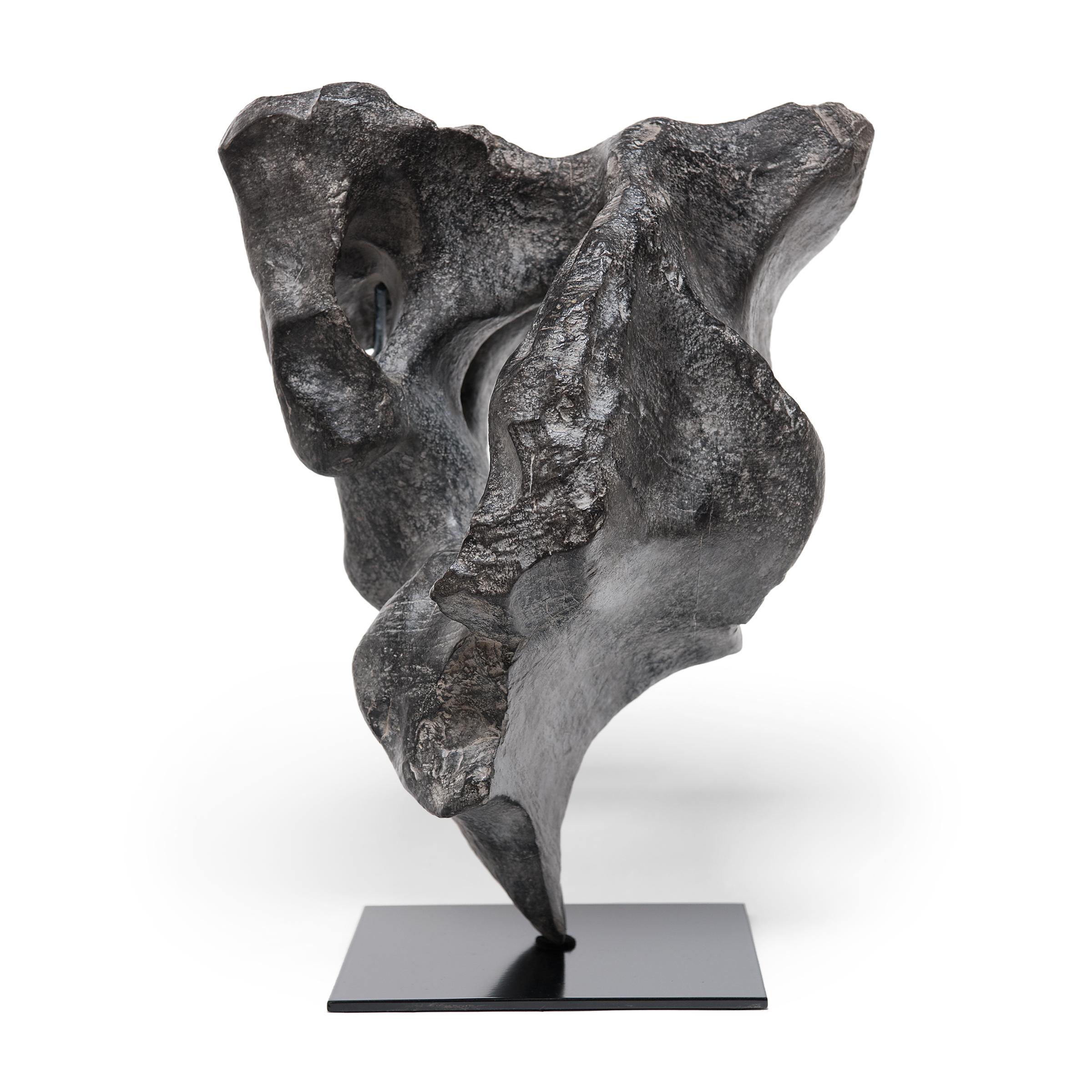 Gracefully balanced on a custom steel base, the unique contours of this lingbi stone inspired its celestial name, 