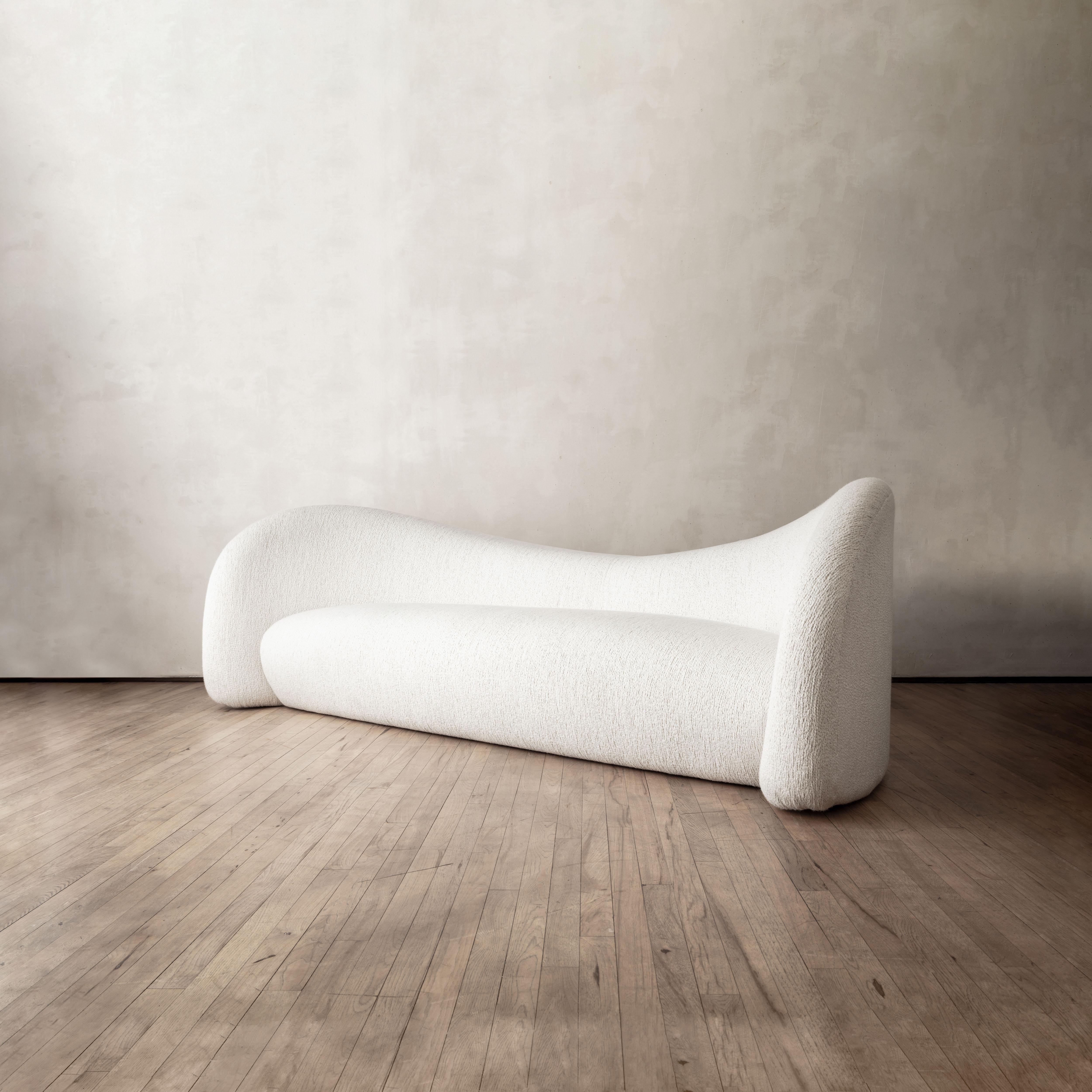 Esteemed atelier Domeau & Pérès collaborates with the Parisian designer Raphael Navot to create the moon sofa, an ergonomic seating solution upholstered in Pierre Frey bouclé. The central back support of the sofa is structured as a seat, which