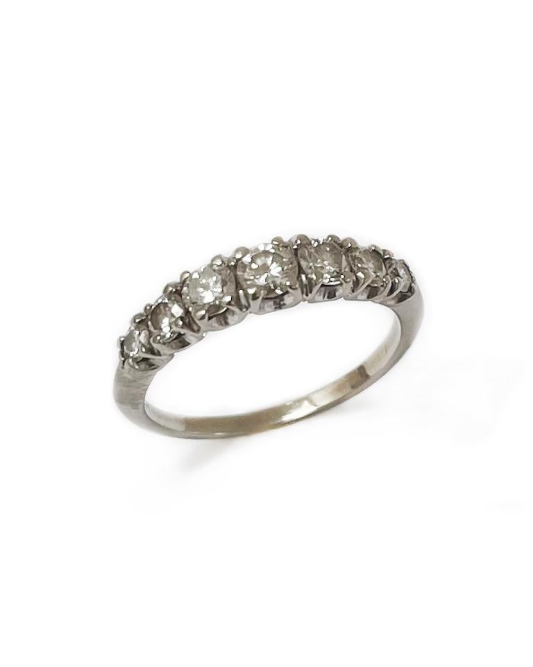Intention: Classic shine

Dorian's Find: This classic vintage diamond ring features seven tapered round brilliant cut white diamonds in a 14k white gold shared prong setting. This would make an excellent engagement band, or stackable ring for