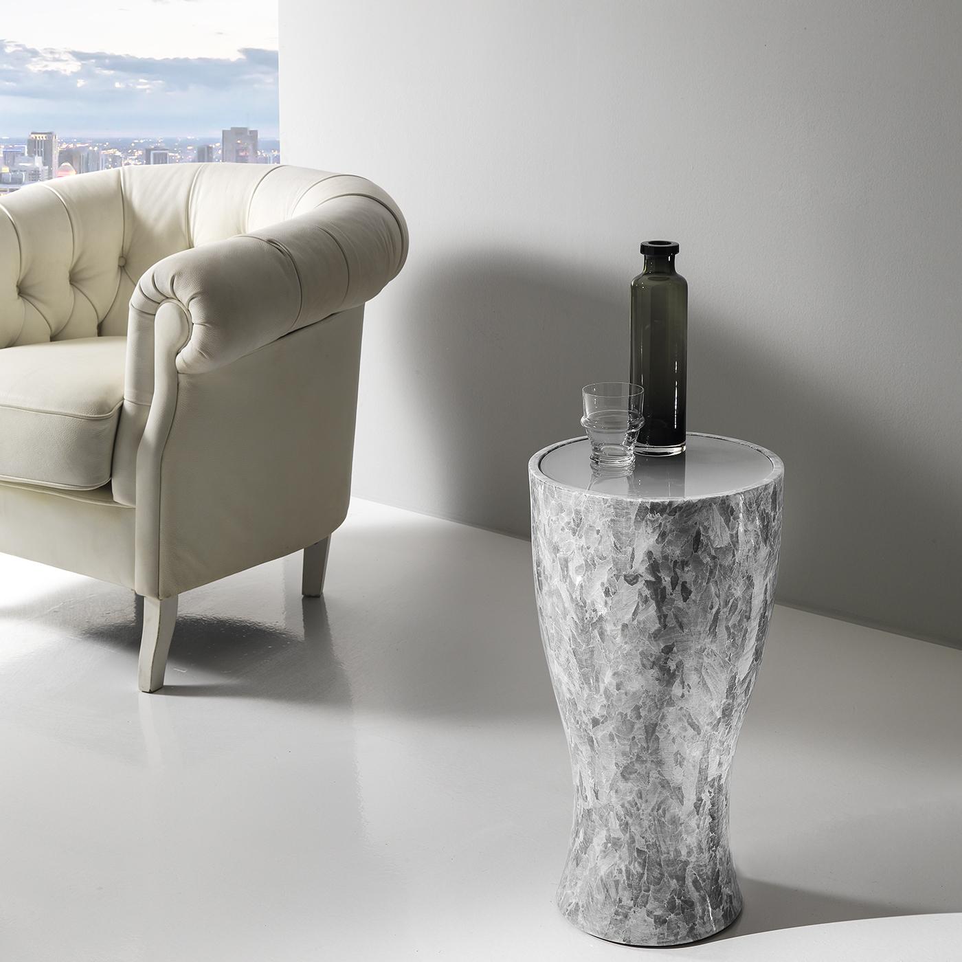 Simple yet breathtaking, this unique side table is entirely handcrafted of Crystal Stone®, a rare alabaster mined from the only quarry in the world located in Italy's Romagna region. Stunning as an end table or bedside table, the softly curved, urn