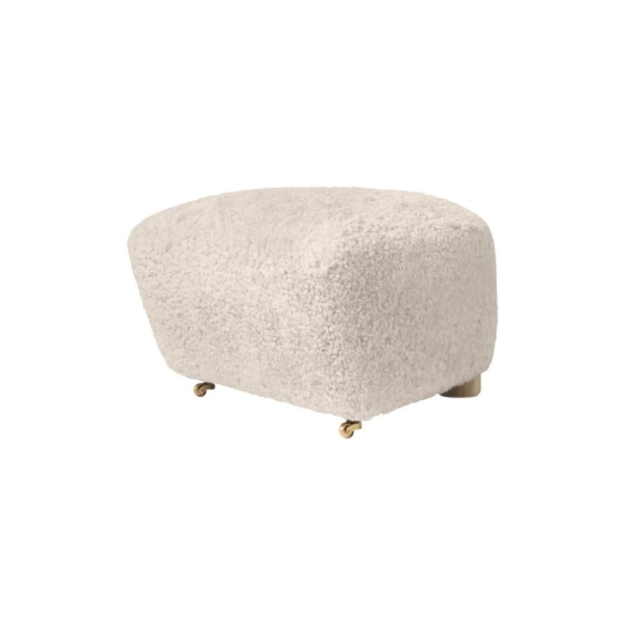 Moonlight natural oak sheepskin the tired man footstool by Lassen
Dimensions: W 55 x D 53 x H 36 cm 
Materials: Sheepskin

Flemming Lassen designed the overstuffed easy chair, The Tired Man, for The Copenhagen Cabinetmakers’ Guild Competition in