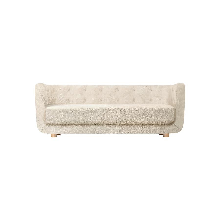 Moonlight sheepskin and natural oak vilhelm sofa by Lassen
Dimensions: W 217 x D 88 x H 80 cm 
Materials: sheepskin, oak.

Vilhelm is a beautiful padded three-seater sofa designed by Flemming Lassen in 1935. A sofa must be able to function in