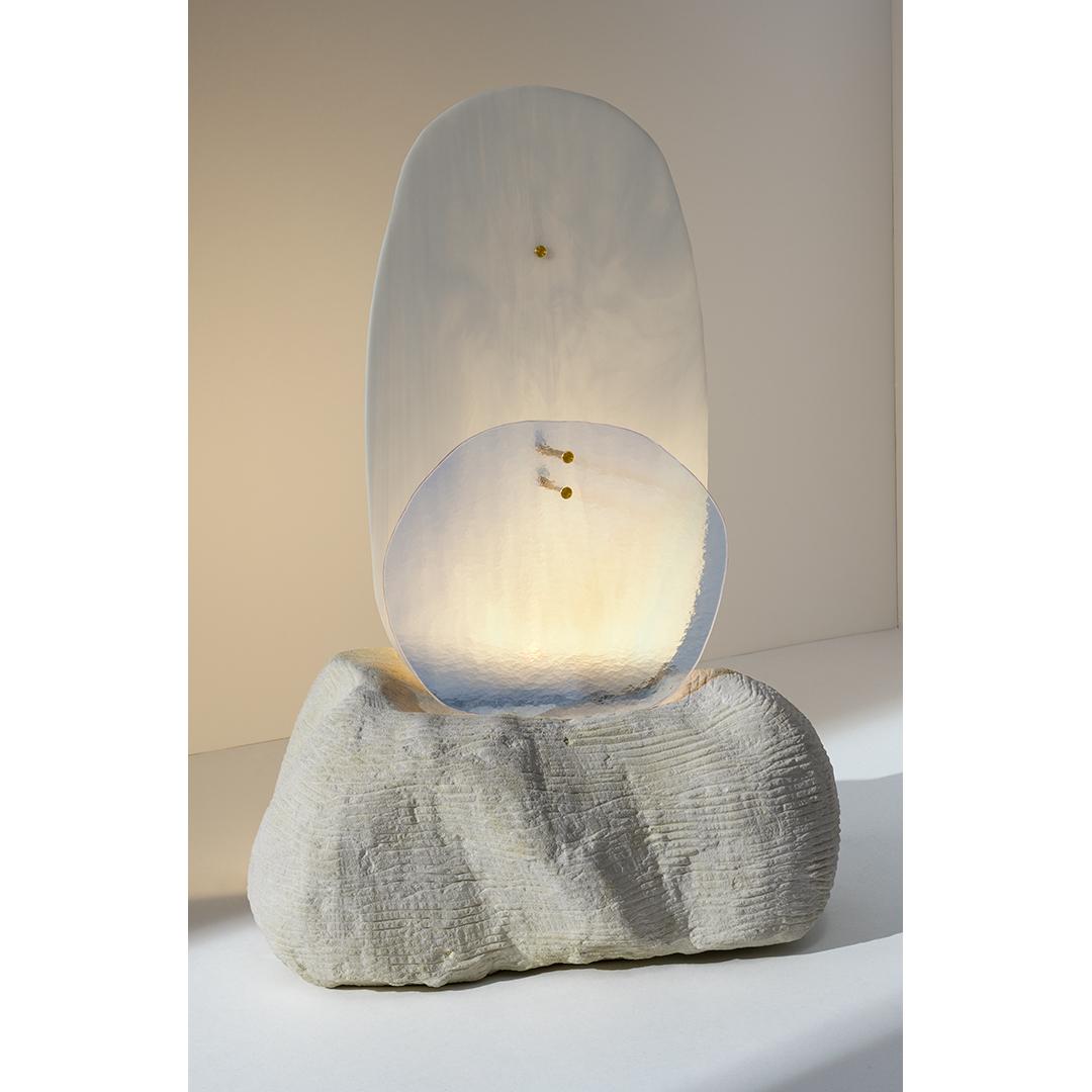 Moonrise light sculpture by Marie Jeunet
Dimensions: W 32 x D 21.5 x H 55.5 cm
Materials: White chamfered glass sheet, sheet of translucent glass hammered lunar blue, Tufa stone, brass finishes

In a sky strewn with white clouds, a moon with blue