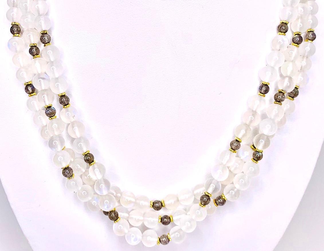 This moonstone and labradorite triple-strand necklace is both fun and versatile! 18k yellow gold spacers add a luxurious touch to the milky moonstone and striking labradorite beads, known for their iridescent flashes of color. A fun necklace to wear