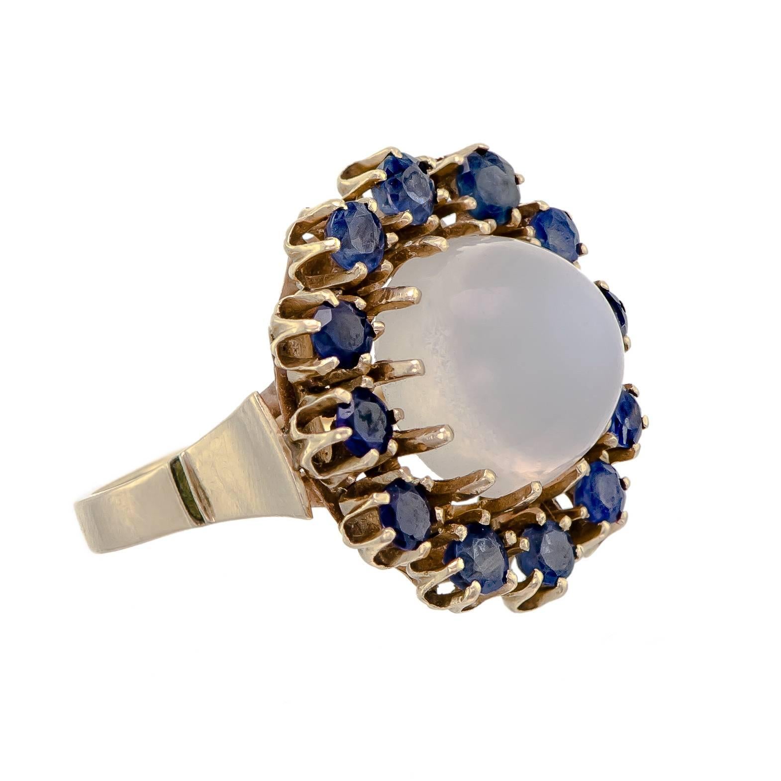 Wonderful Vintage estate cocktail ring glamorous in details moonstone and sapphire 14k yellow gold ring centrally set with one large white moonstone cabochon surrounded by twelve (12) prong set round brilliant cut deep blue sapphires - 14k mount -