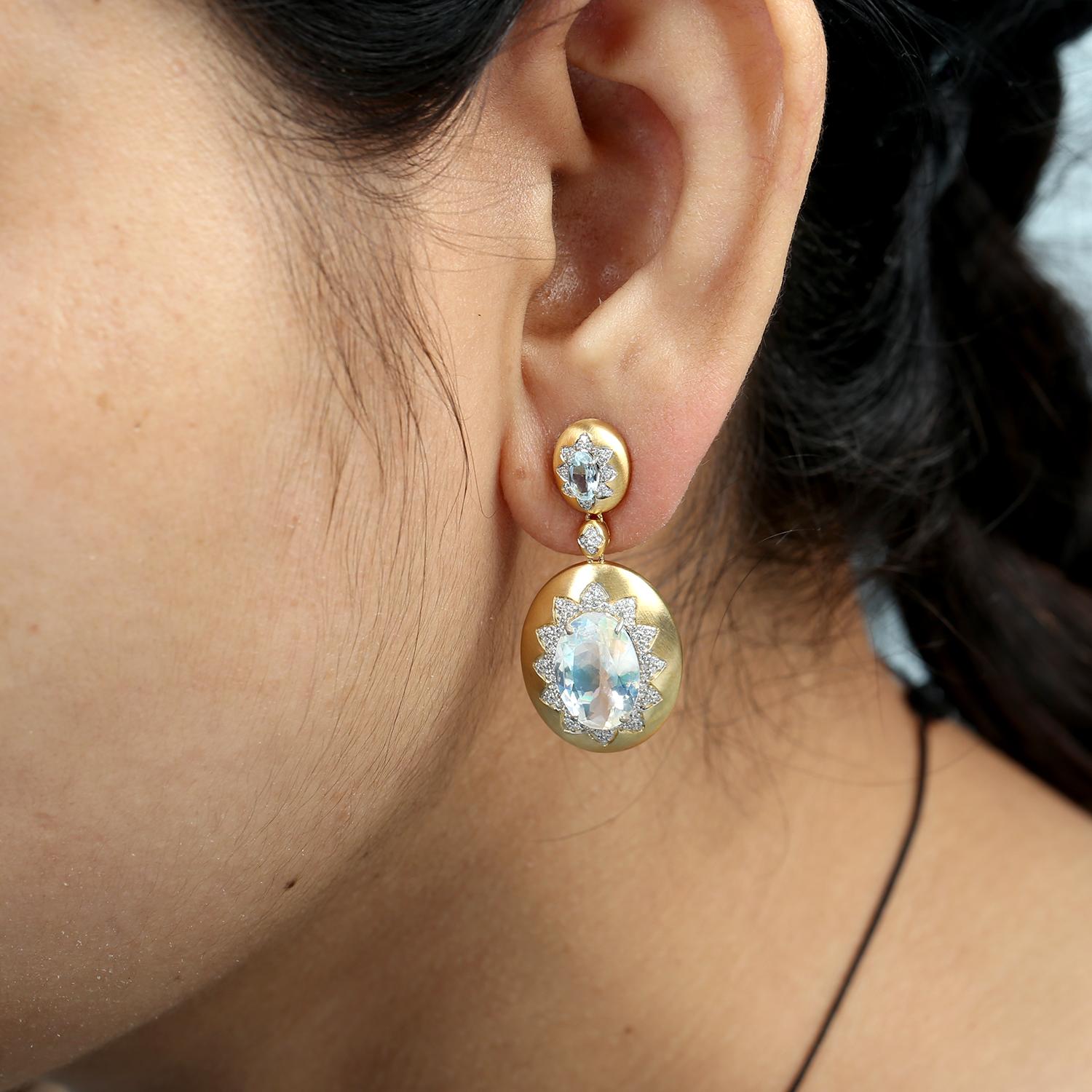 A statement design featuring the dreamy glow of moonstone paired with the serene blue of aquamarine. Crafted in 14k gold, these dangle earrings are accented with diamonds for added brilliance, creating an elegant look perfect for special