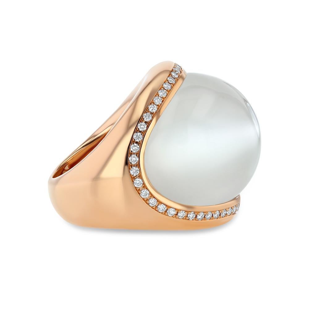 Our 18 karat rose gold Moonstone Bubble Ring is a modern wonder. With x diamonds encasing a horizontally stretched and curved moonstone slab the piece is white, bright, and reminiscent of the beautiful moon in the night sky.