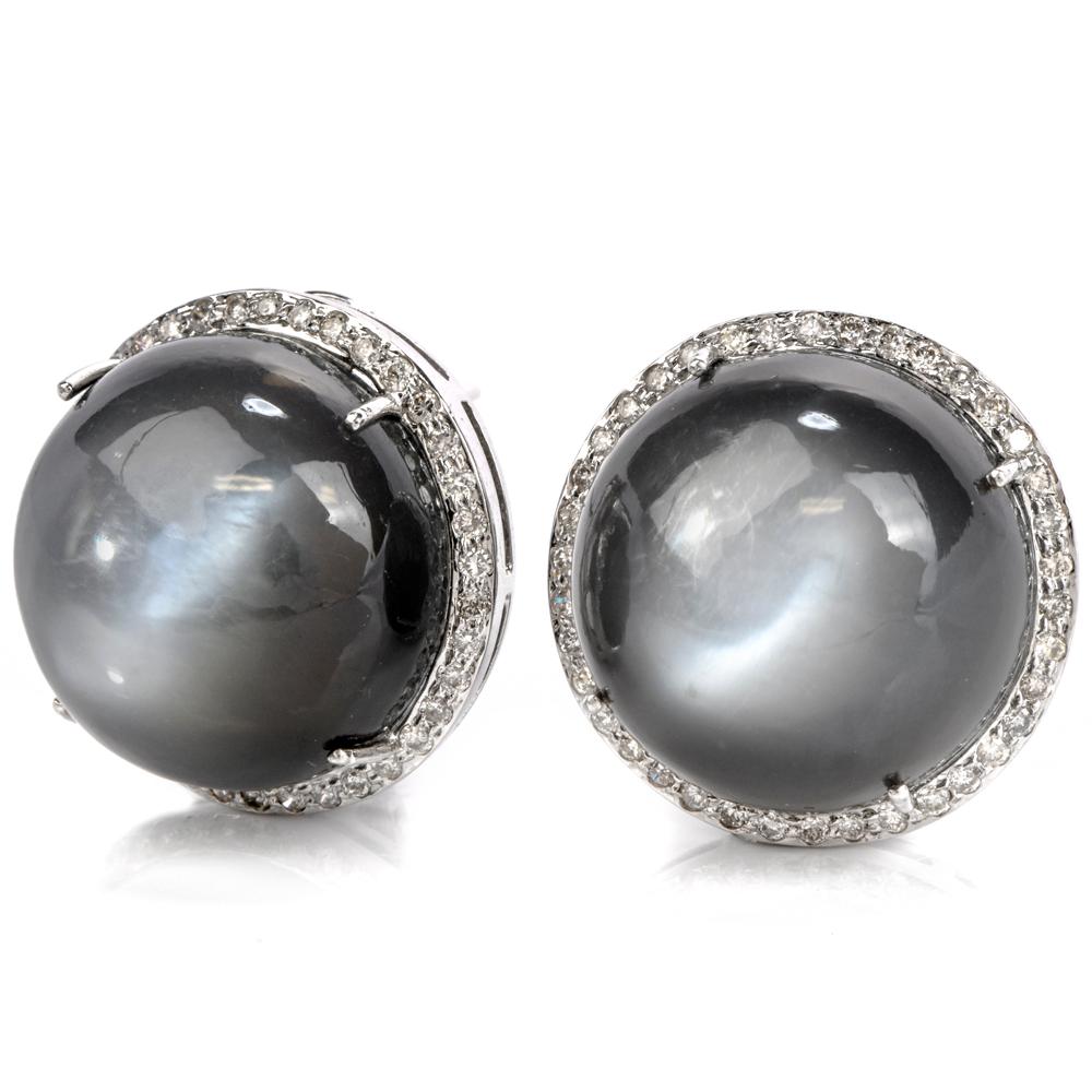 These whimsical stud earrings are crafted in18 karat white  gold.

Centered with two moonstone cabochons, weighing approx 48.85 carats in total,

surrunded by over 100 round natural dimaondsweighing approx. 0.90 cartas

H-I color, VS2-SI1 clarity,
