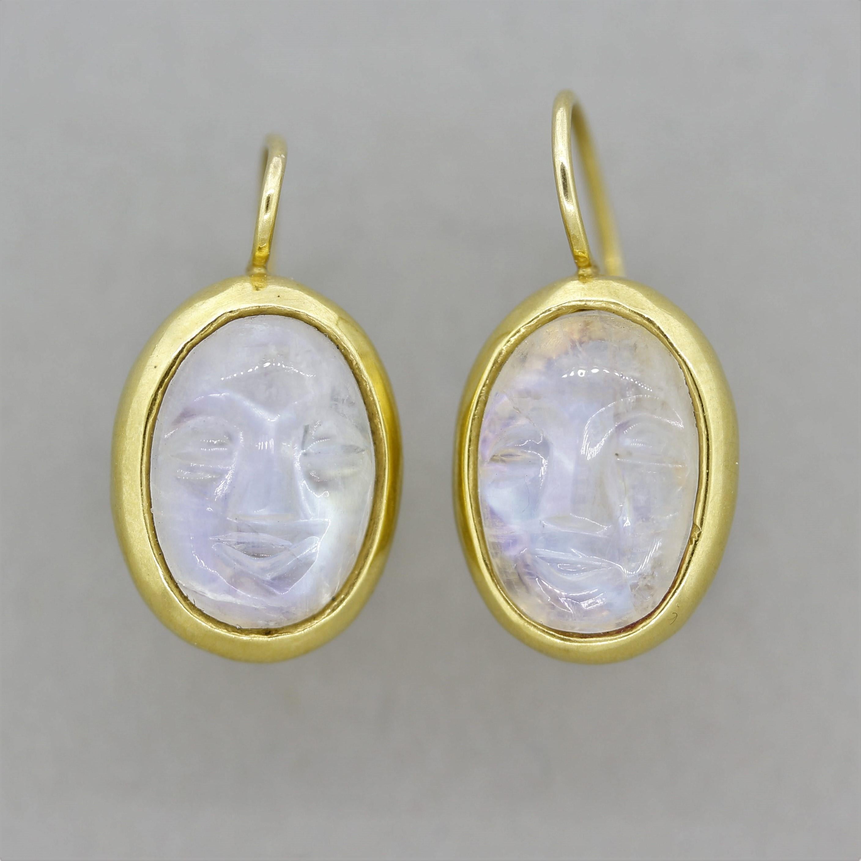 A special unique pair of earrings featuring two moonstone cameos which are hand carved to depict faces! The moonstones are of excellent quality as bright blue flashes roll across the gems surface, which is known as adularescence (a unique phenomenon