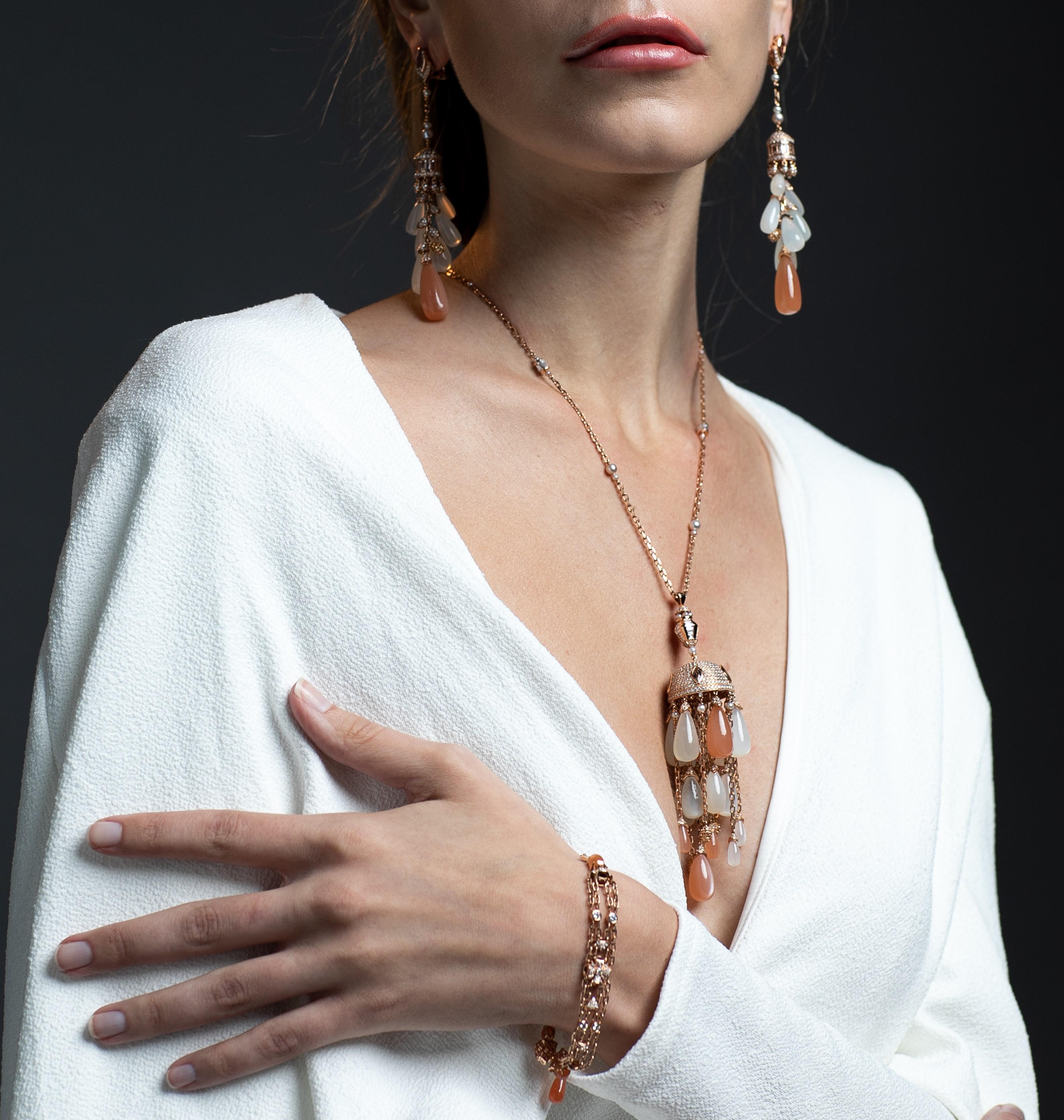 A mesmerizing moonstone chandelier collection inspired by the architectural chandeliers in Indian palaces. This is a playful bracelet which elegantly dangles, it has been accented with fancy color gems to bring a sparkle to the intricate design.
