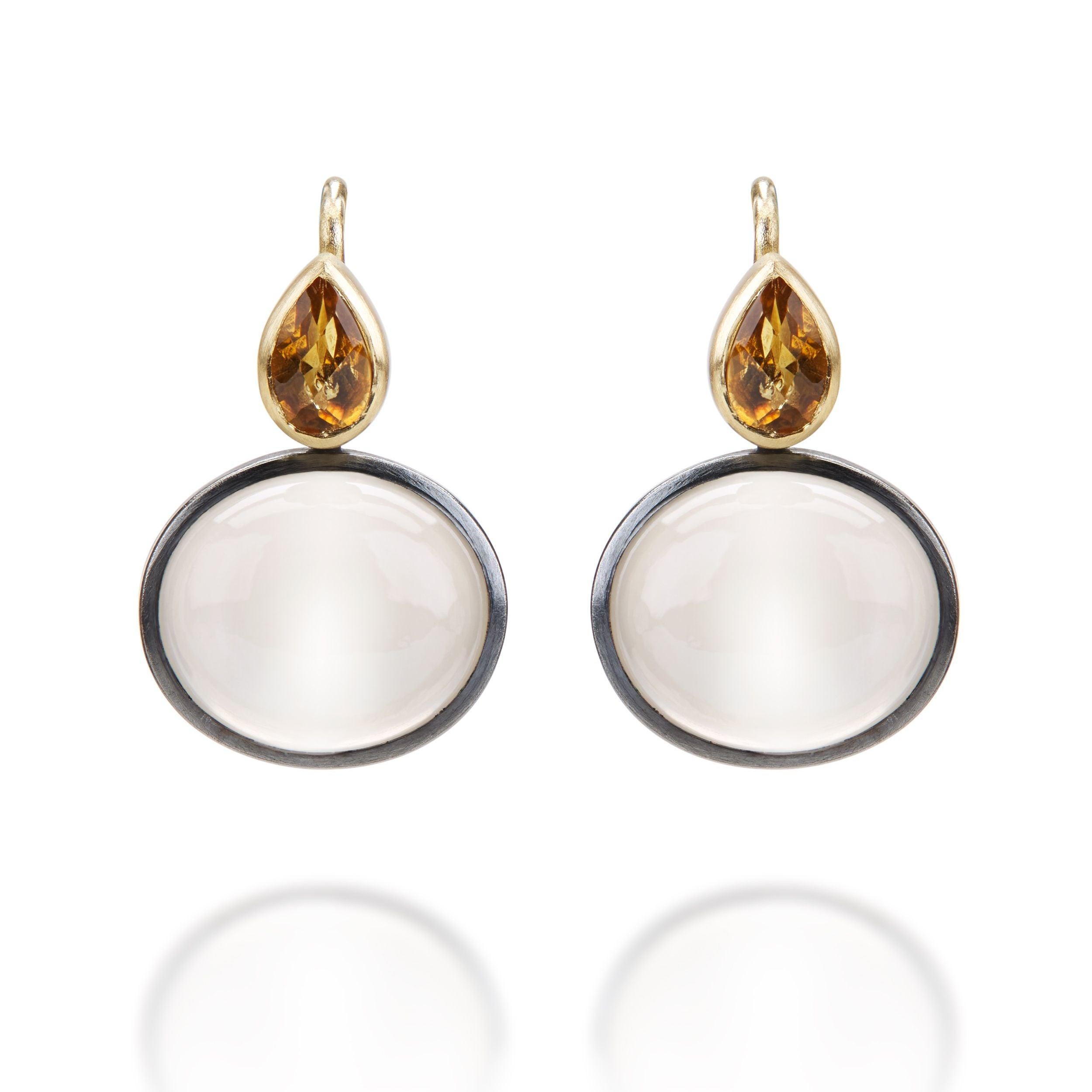 These very contemporary moonstone,citrine, 18K gold, and oxidised sterling silver drop pierced earrings are designed and made by London jeweler, Lucy Martin. Lucy creates art jewelry with a unique sense of color, composition and asymmetry. Inspired