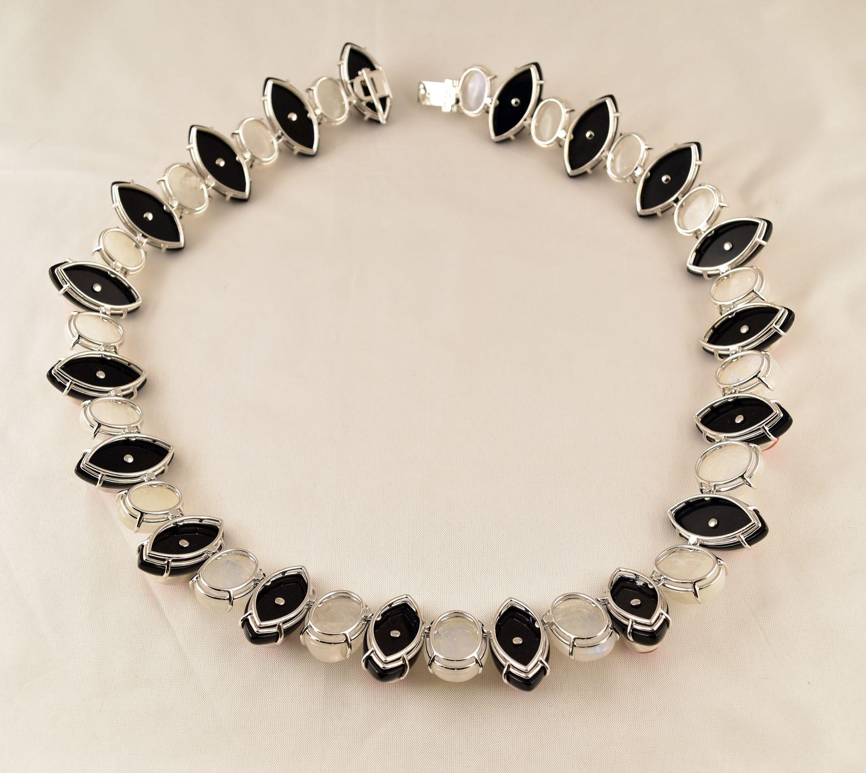 Simply Beautiful! Elegant and Finely detailed Moonstone (app. 367 total Carat weight), Coral (app. 539.6 total Carat weight), Black Onyx (app. 440 total Carat weight) Statement Necklace. Hand crafted in 18K white Gold; Signed: TONY DUQUETTE 18K;