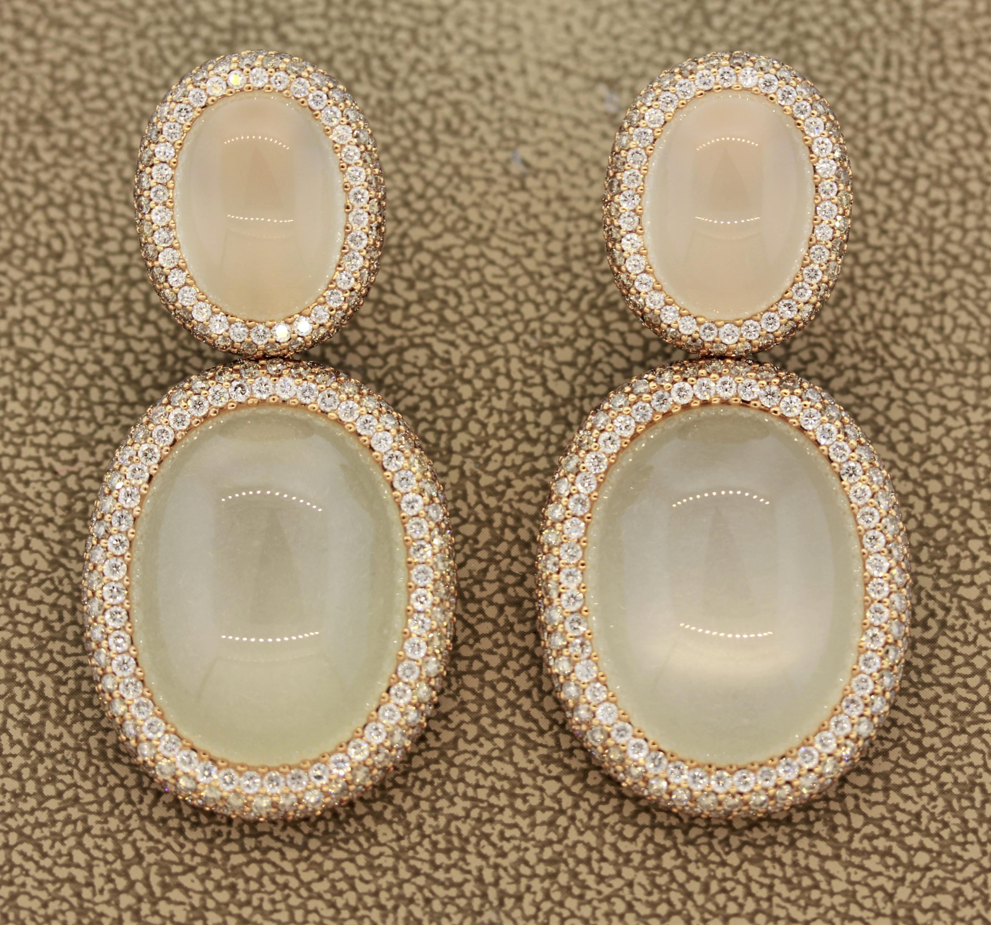 A sweet pair of earrings featuring 4 matching moonstones. They weigh a total of 57.19 carats and have great luster with light softy rolling across the stones. They are complemented by 6.72 carats of round brilliant cut diamonds which are set around