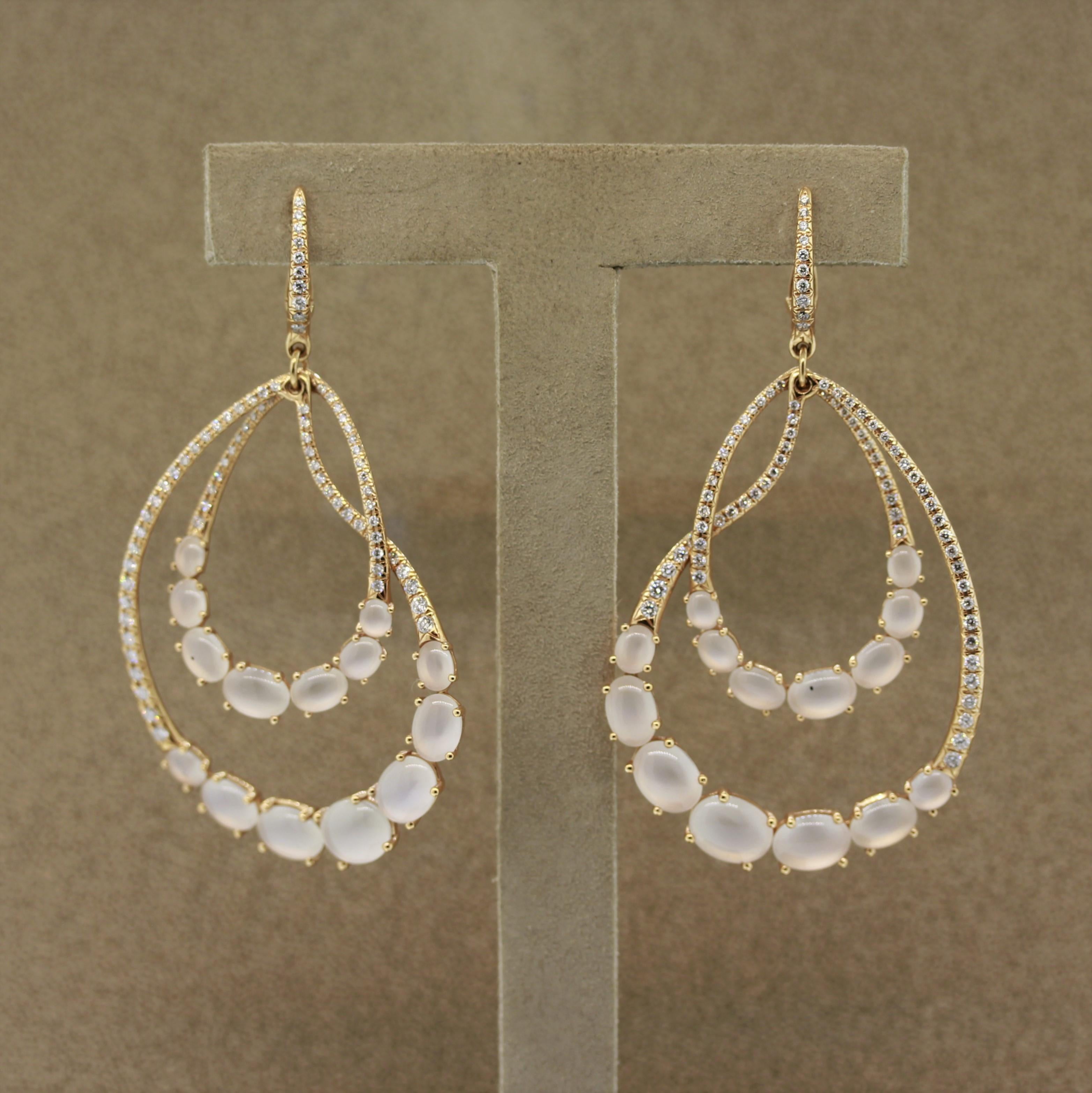 A unique pair of earrings that feature moonstones and diamonds. There are a total of 28 fine moonstones that glow as light rolls across their surface, which is called adularescence (moonstones unique phenomenon). Additionally there are 2.00 carats