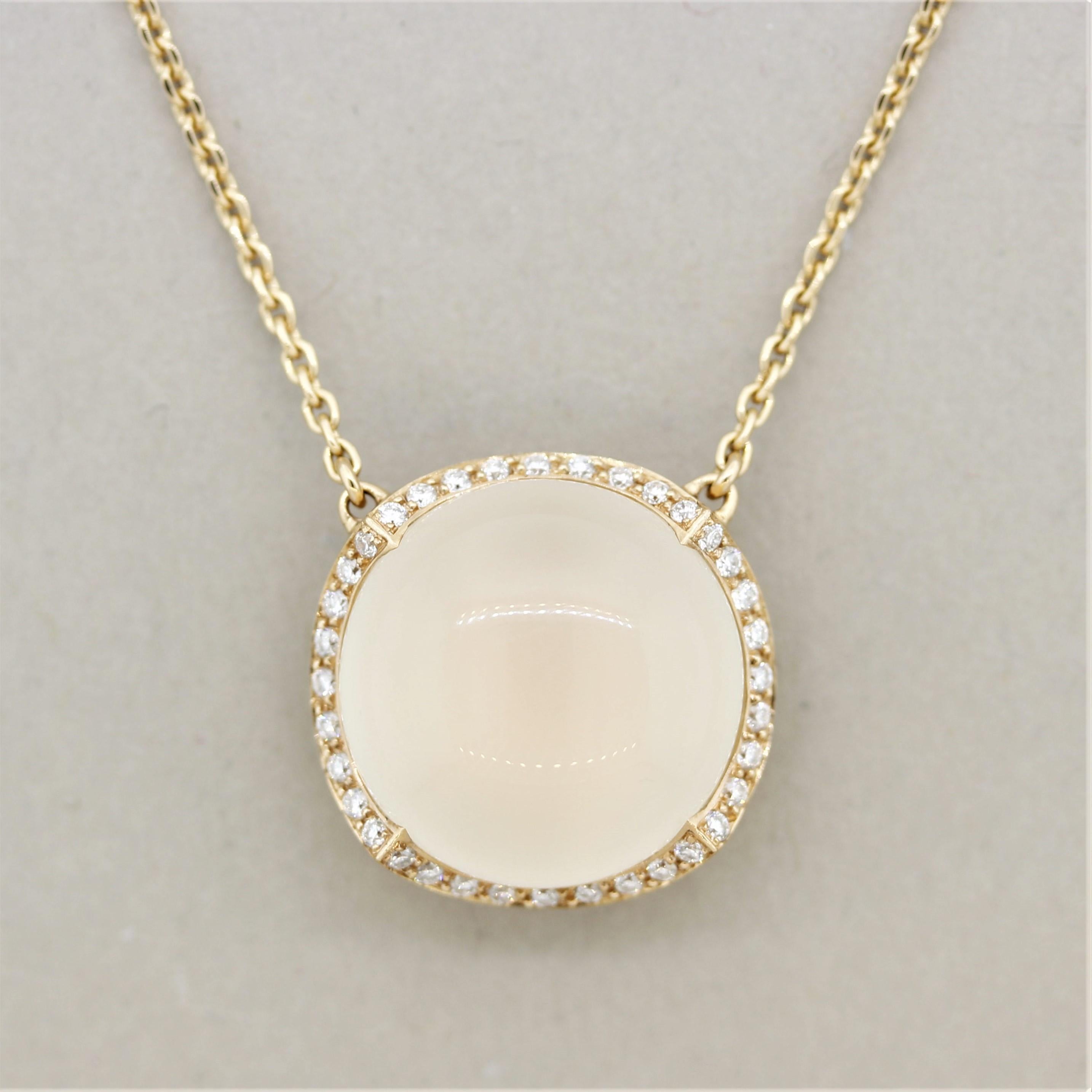 A classy and elegant necklace featuring a 14.97 carat moonstone. It has a lovely cream color with excellent luster as light rolls across the stone. It is accented by a halo of round brilliant-cut diamonds weighing 0.28 carats which add sparkle and