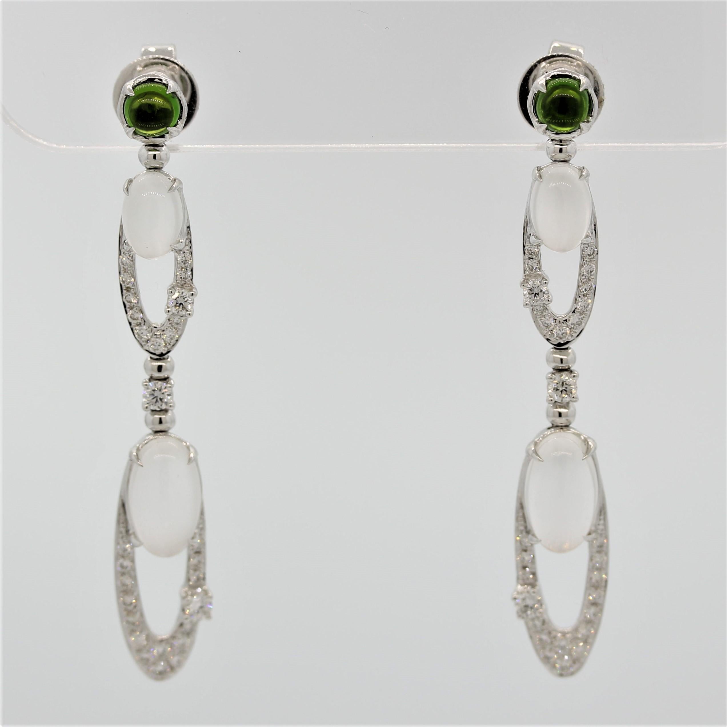 A stylish pair of earrings with a unique combination of gemstones. It features 4 moonstones weighing a total of 15.27 carats, which have great adularescence (special phenomenon of moonstones). They are accented by 0.66 carats of round brilliant cut
