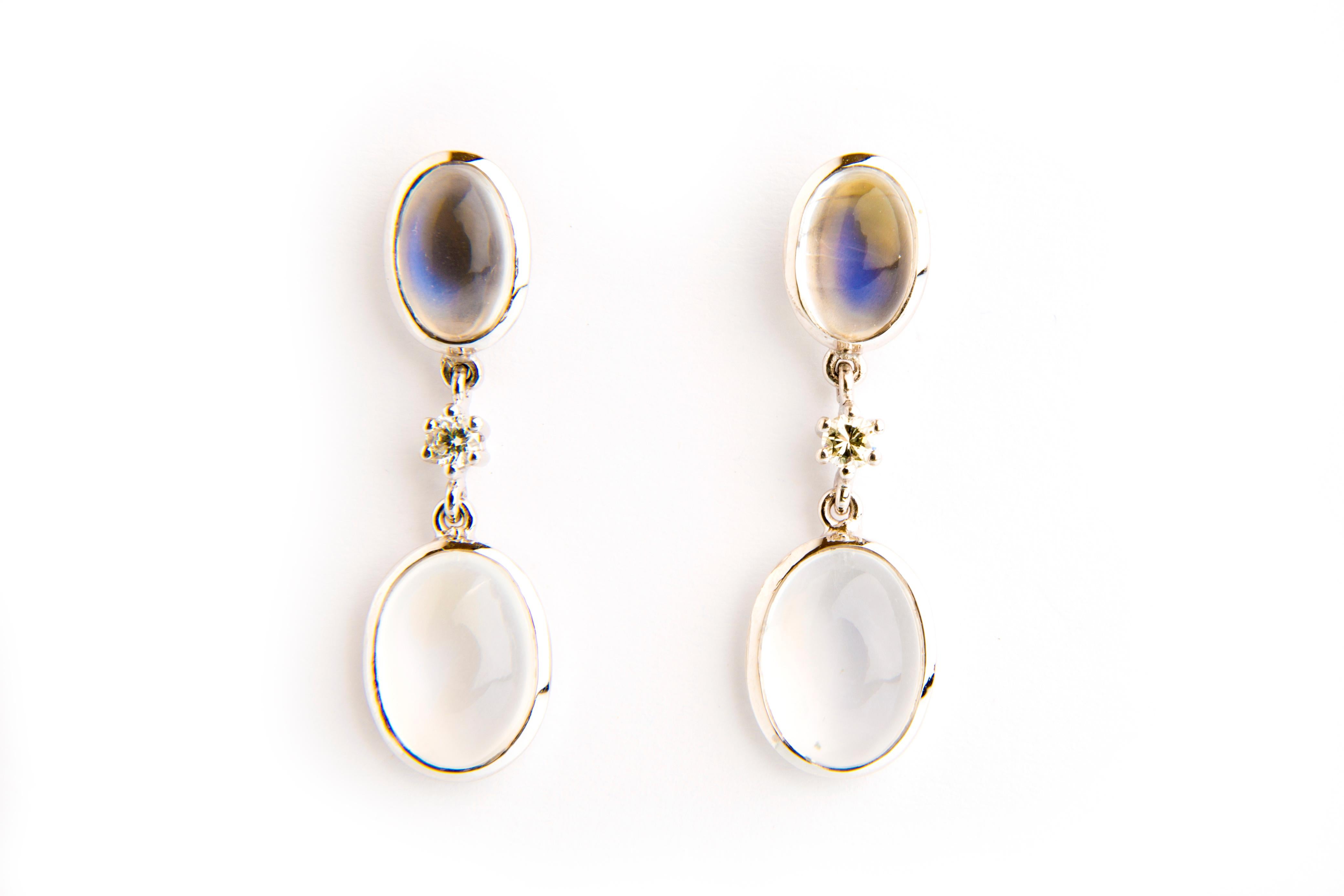 These absolute and unique earrings feature moonstones 10.58ct (4 stones) in a white gold 18k setting with diamonds 0.09ct. The reflection of light will enhance the powerful colors of each stone revealing their inner beauty. They could perfectly