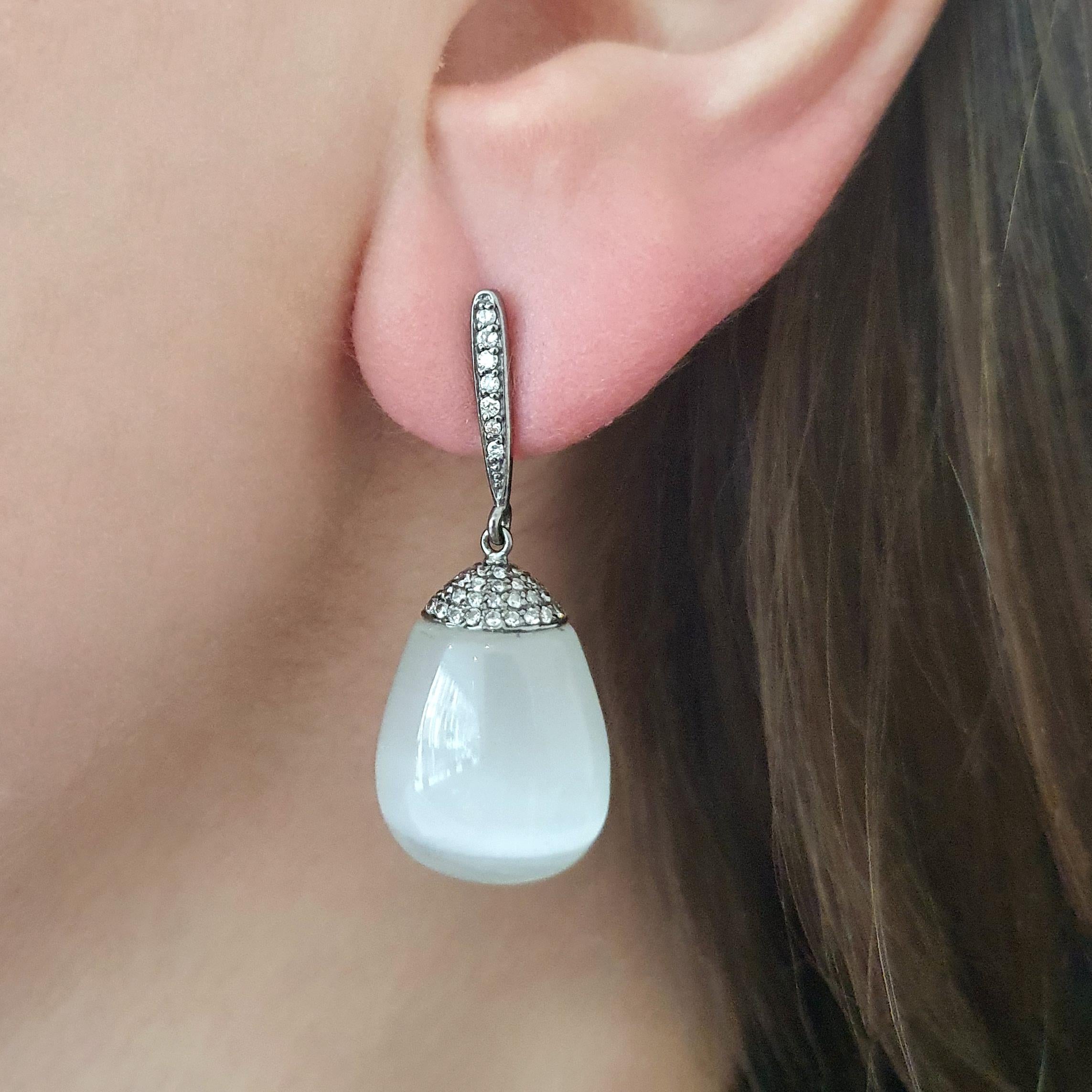 MoonStone significant drops on Diamond and Blacken Gold Ear Pendants.
Contemporary work.

Total length: 1.57 inch (4.00 centimeters).
Width at maximum: 0.59 inch (1.50 centimeters).
Total weight: 13.69 grams.