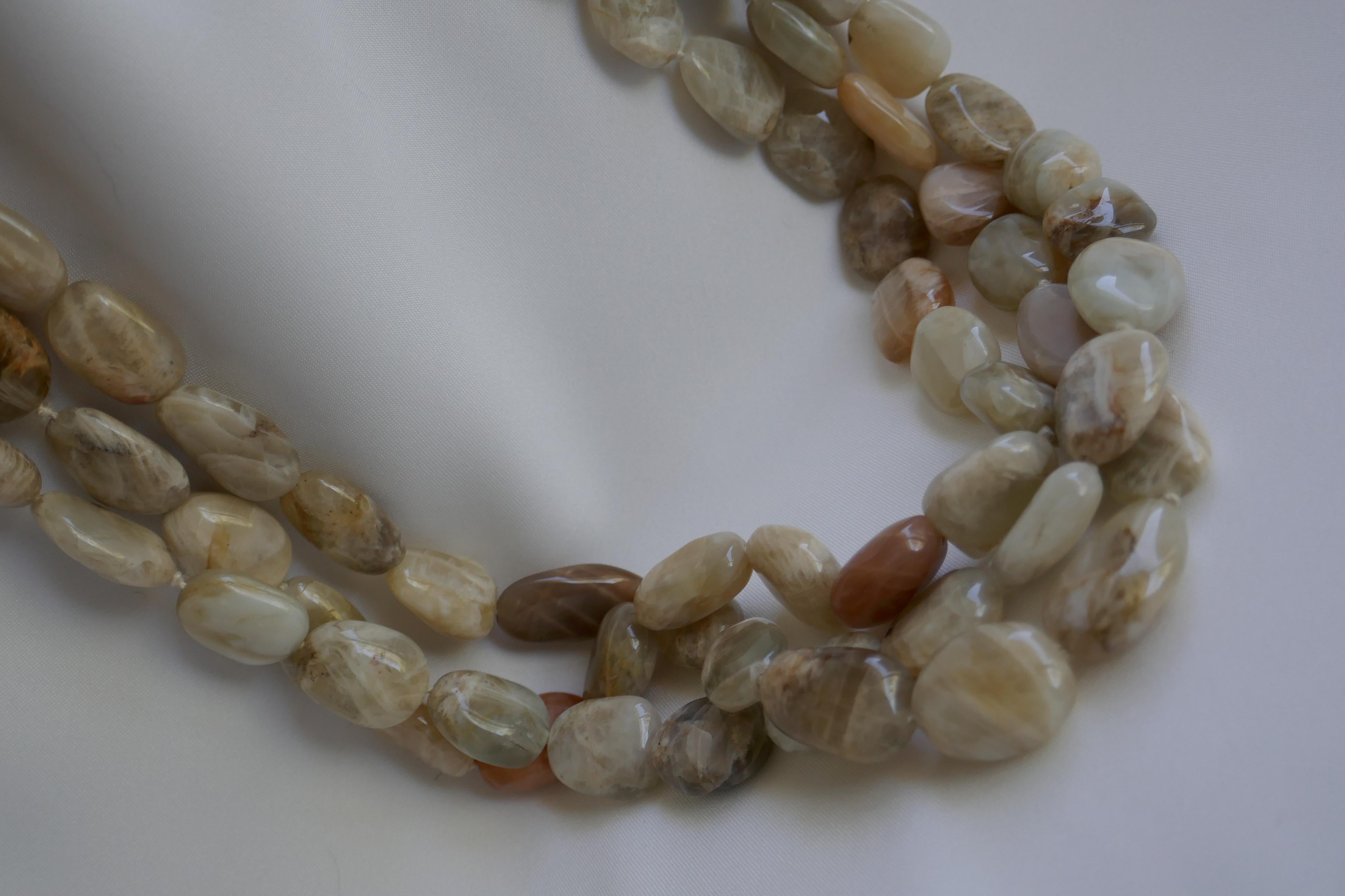 Love moonstones!!! This a stunning statement necklace. This three strand nugget moonstone necklace has beautiful stones the nuggets are in a pale peach, off white and beige tones.The tones of this moonstone necklace are beautiful. The size of the