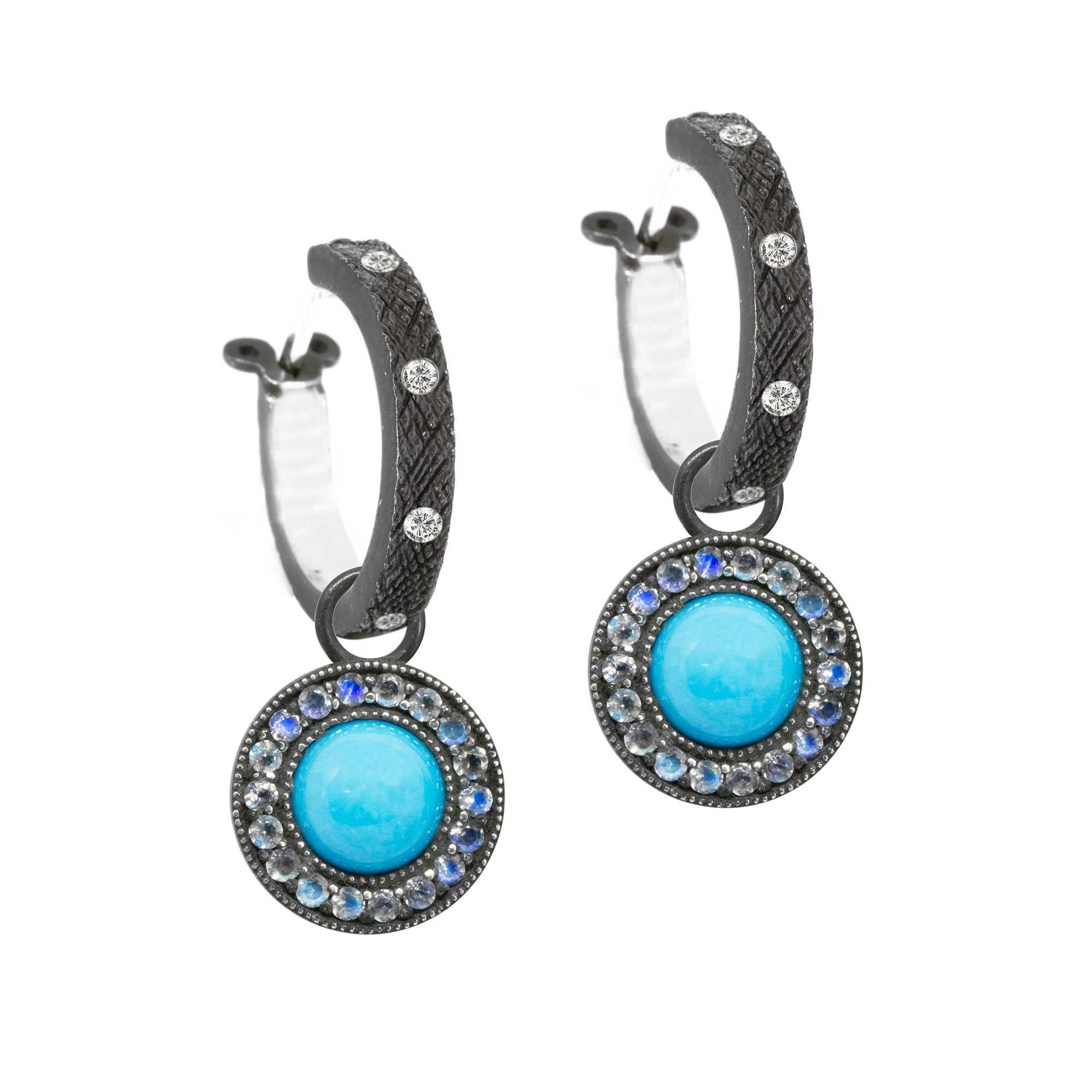 In the Moonstone Orbit Oxidized Charms, concentric circles of engraved blackened silver and luminous moonstones surround sleeping beauty turquoise cabochons for a cool mix of textures and lusters. They pair with any of our hoops and mix well with