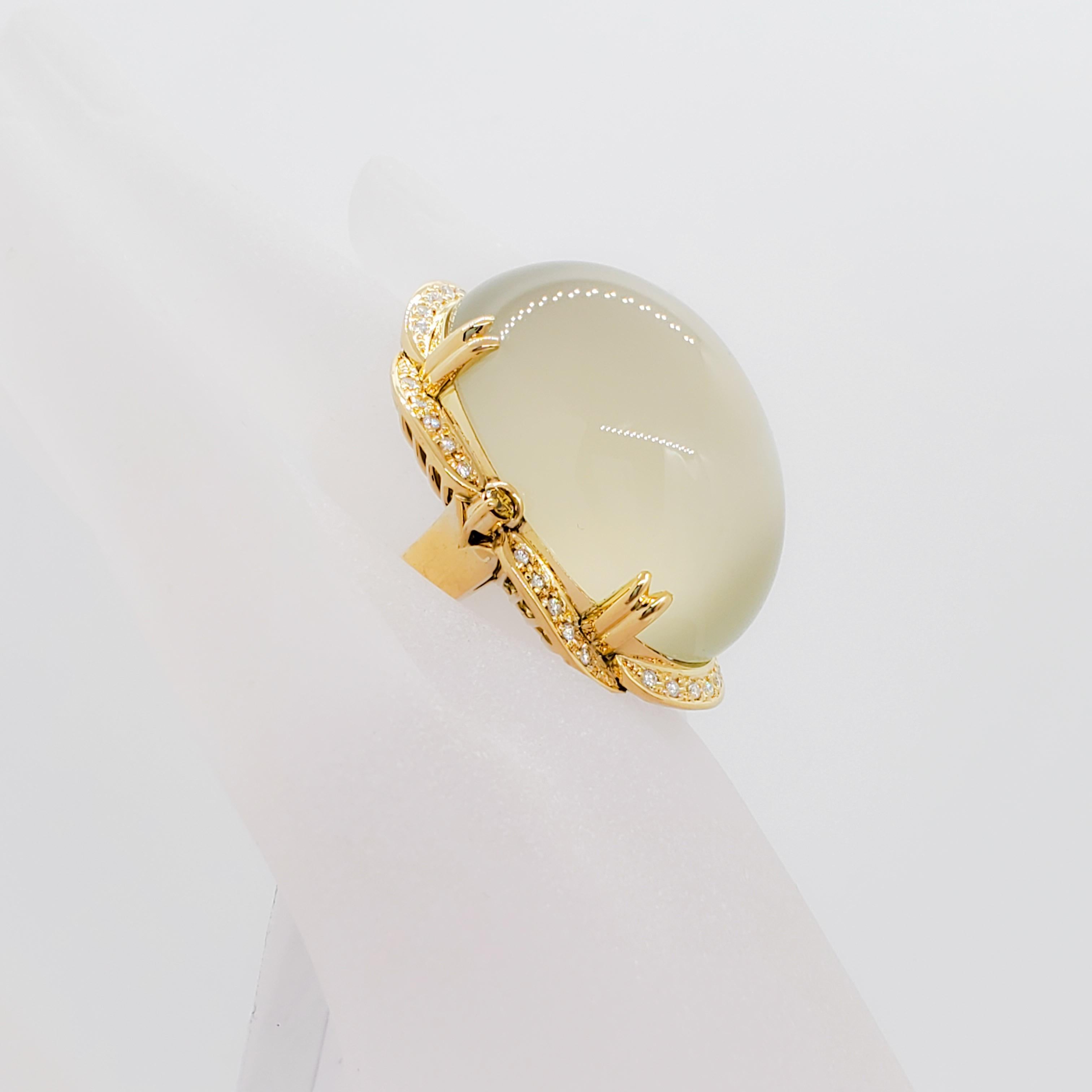 Spectacular 118.85 ct. moonstone oval cabochon with 0.61 ct. of good quality white diamond rounds in a handmade 18k yellow gold mounting.  This ring has a strong presence not only because of size but because of it's beautiful design.  Estate piece