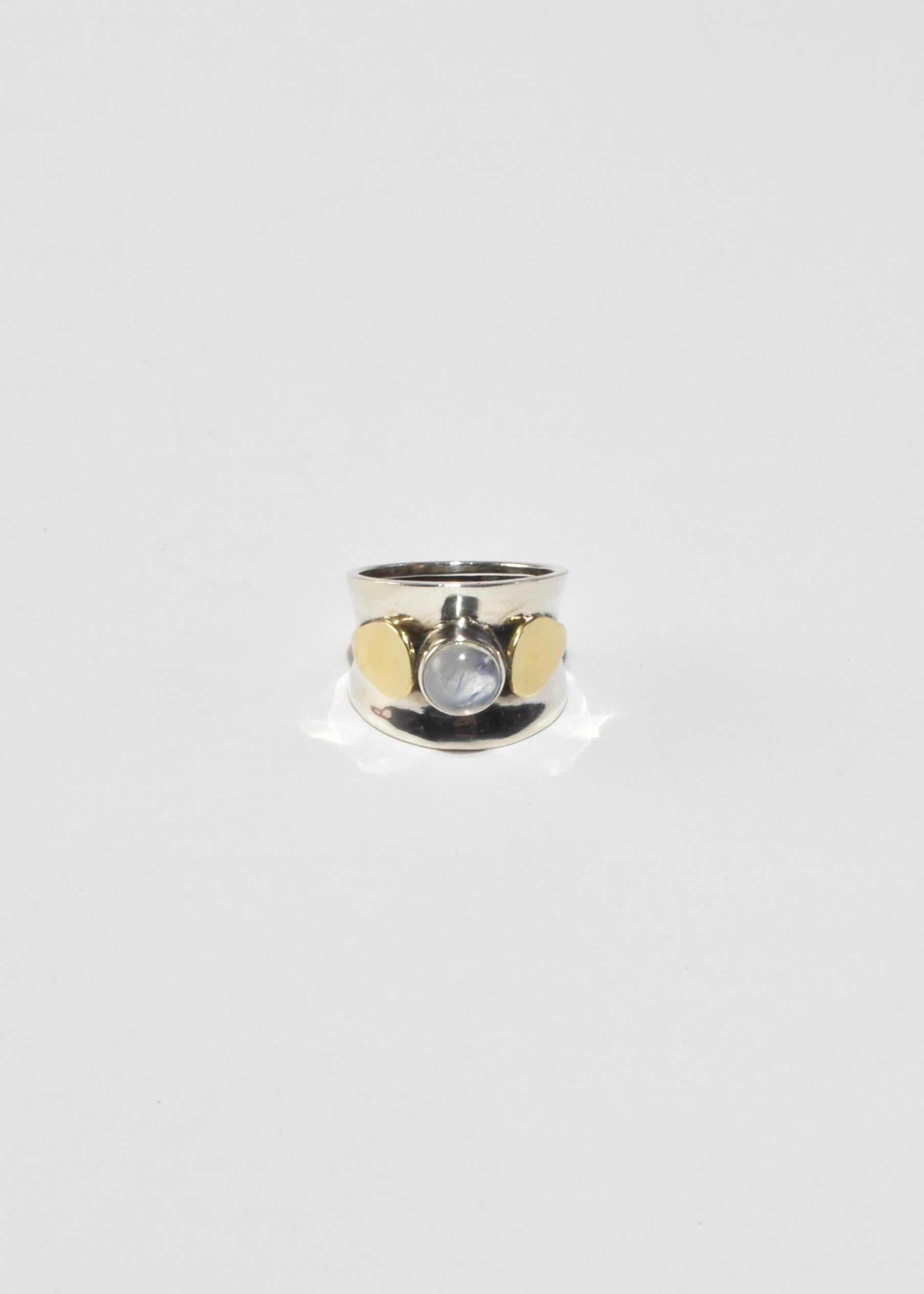 Rare, vintage wide band sterling ring with a round moonstone cabochon and gold petal detail. Stamped 925.

Material: Sterling silver, 14k gold, moonstone. 