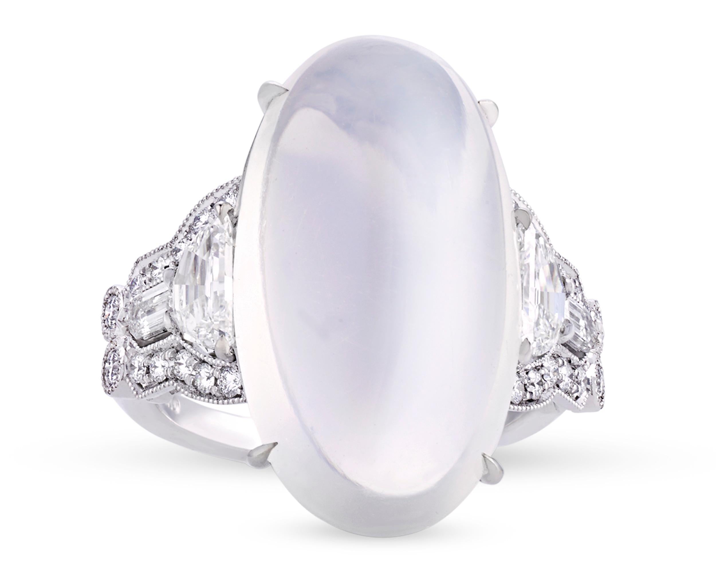 A monumental 12.46-carat oval moonstone cabochon is set in this classic Art Deco-style Raymond Yard ring. The gem displays the stunning opalescence that makes this stone so beloved, exhibiting a lovely purplish-grey hue and exceptional play of