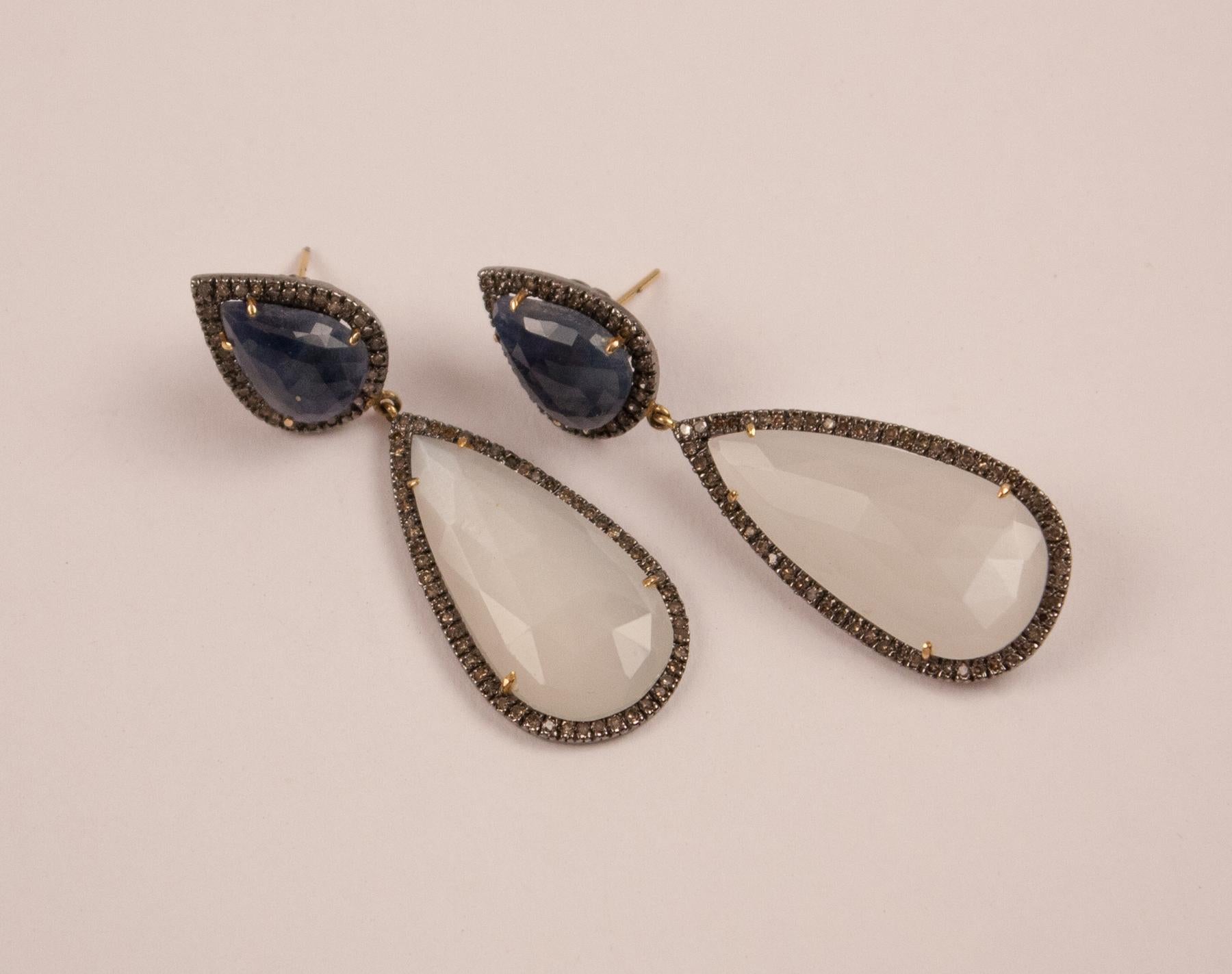 Stunning pair of dangle earrings featuring a sophisticated combination of faceted moonstone and blue sapphire, both framed by diamonds pave set in sterling silver.
Moonstone: 30.40 grams
Sapphire: 10.50 grams
Diamond: 1.85 carats   
