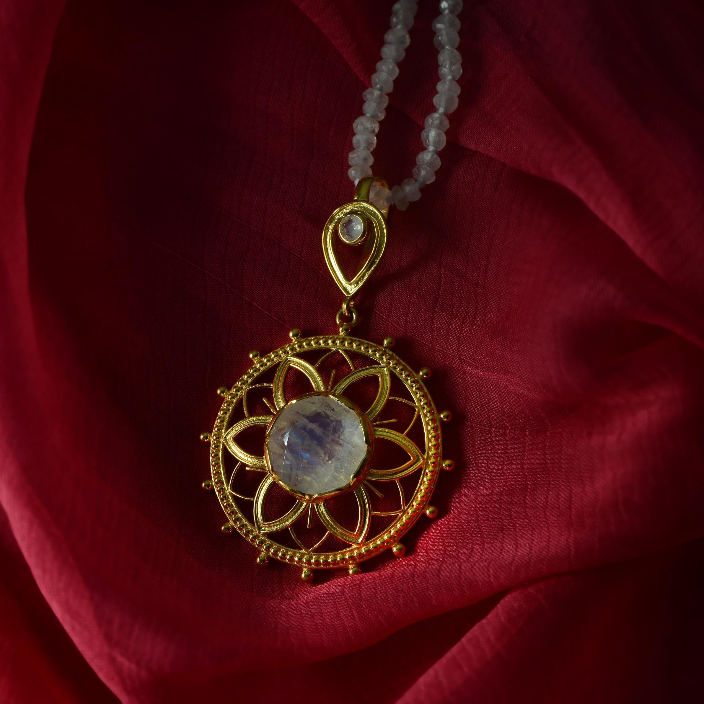 

This exquisite moonstone statement pendant has been handmade in our workshops. We have used the ancient techniques of jaali, hand engraving and embossed work and embedded the pendant with rainbow moonstones. The patterns have been inspired by