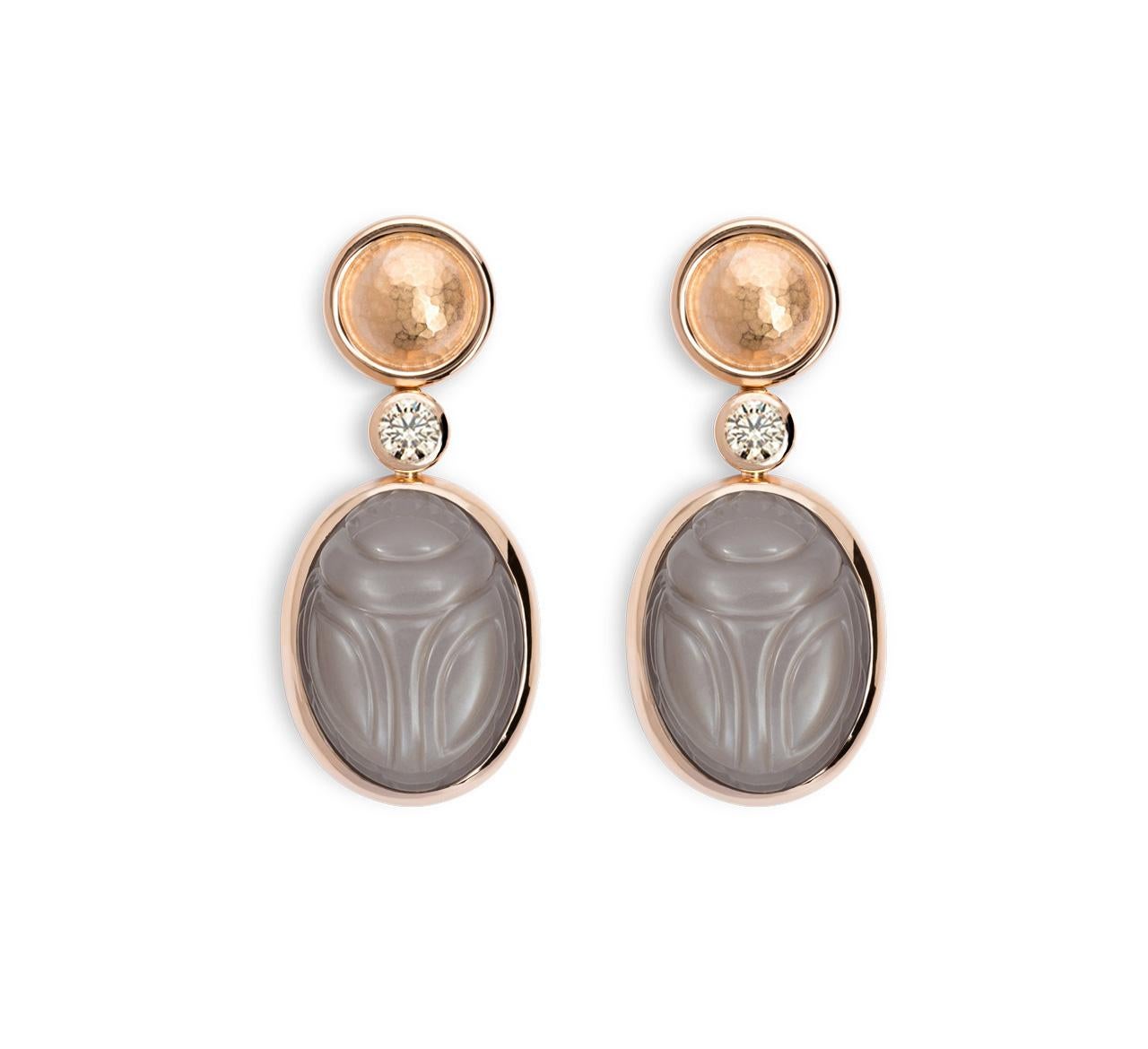 A pair of rose gold dangle earrings with two moonstone scarabs 36,41 ct and two light-brown brilliant-cut diamonds 0.53 ct. Just beautiful.
Designed by Colleen B. Rosenblat