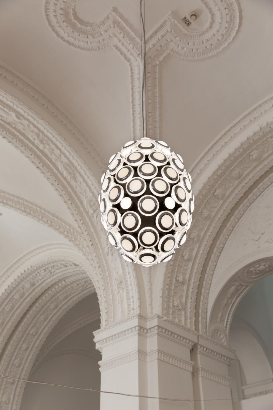 The first sparkle of this great idea was inspired by iconic automotive headlights. They have been modified to design a grand pendant light with a classy, powerful impact for the foyer of the Bavarian National Museum in Germany. The light’s oval