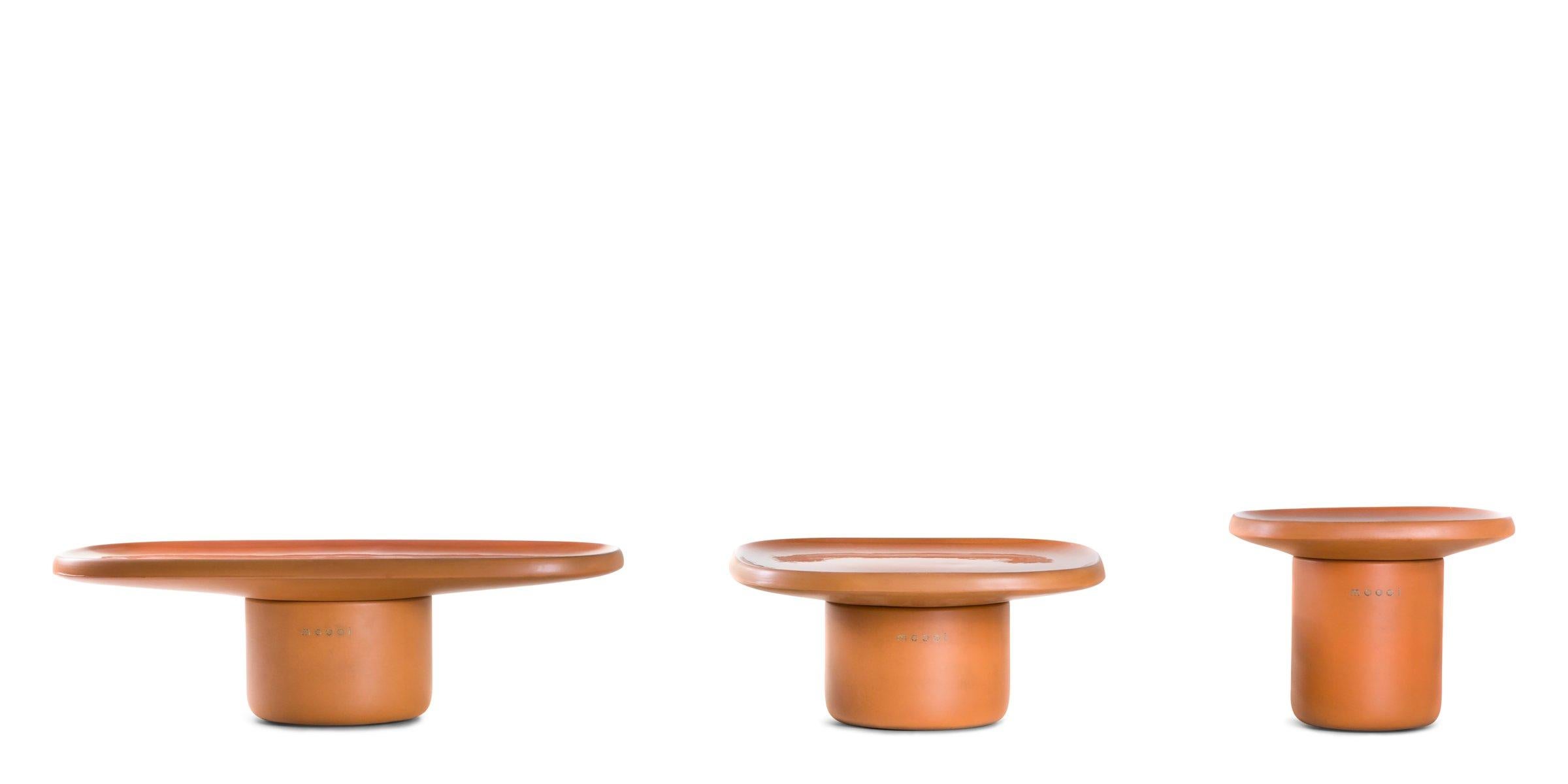 Obon is a collection of three tables inspired by an ancient, earthy, irregular material: terra-cotta. With its origins lost in the mists of time, terracotta is at the base of millenary archaeological finds all over the world. These precious