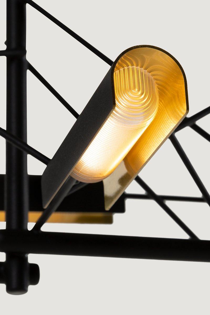 Tinkering, designed by Joost van Bleiswijk, captivates its spectators through a rhythmic composition that is made from black coated stainless steel and brass. This suspension lamp is available in two sizes, Tinkering 85 and Tinkering 140, which