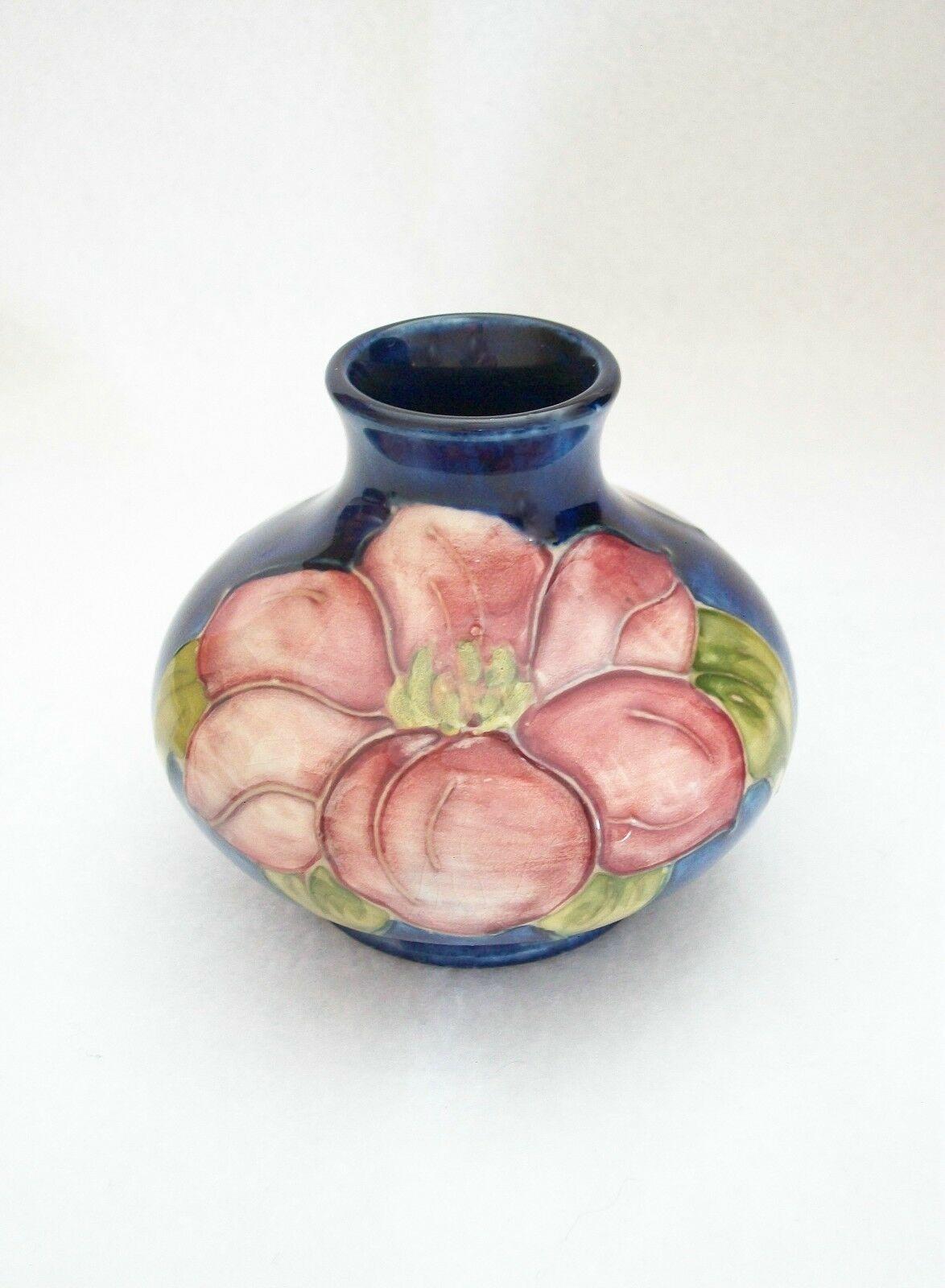 MOORCROFT - 'Clematis' - Vintage Arts & Crafts ceramic vase - hand painted with a blue background - impressed stamps to the base - U.K. - circa 1950-86. 

Excellent condition - no loss - no damage - no restoration - minor signs of age and