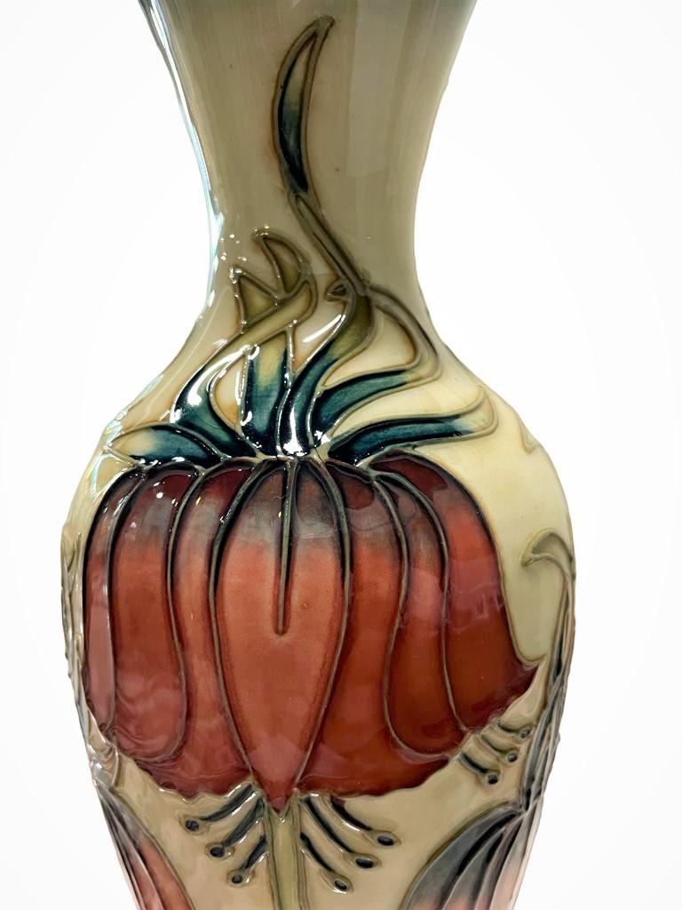 Moorcroft Crown Imperial Vase By Rachel Bishop, limited edition no 18/600.
A charming Moorcroft pottery vase in the ‘Crown Imperial’ pattern designed by Rachel Bishop dated for 1997.
The vase is of a slender baluster form with a flared neck.
It has