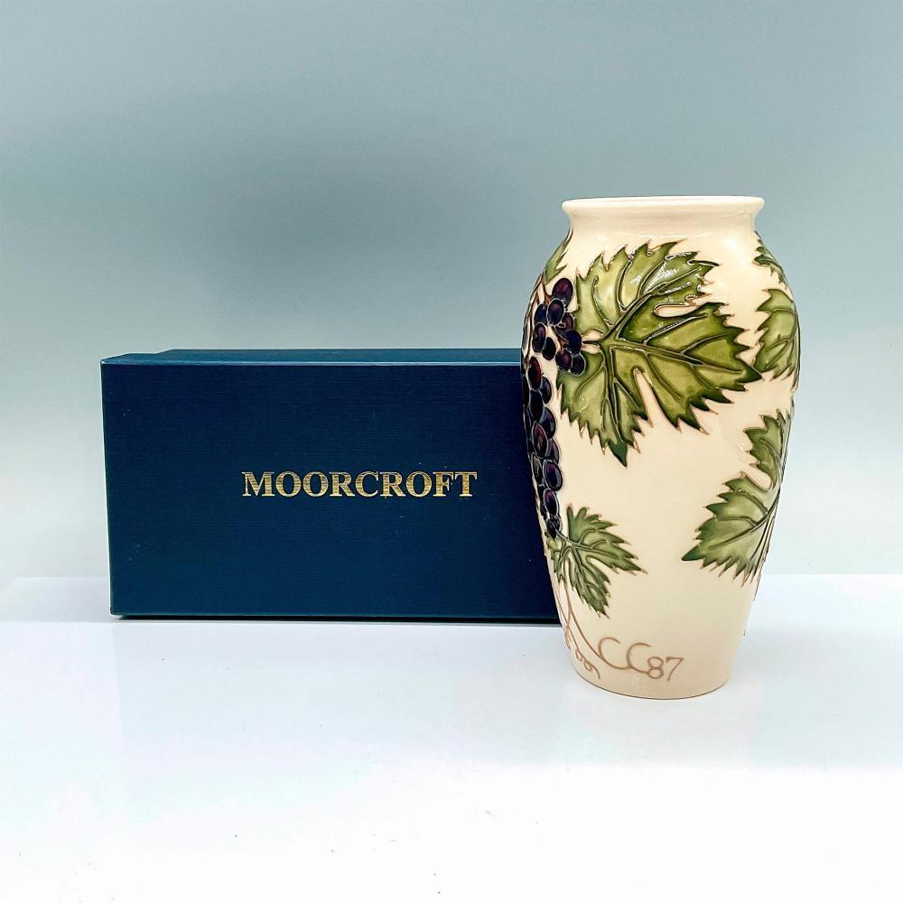 A Moorcroft Pottery vase, ‘Grapevine’ designed by Sally Tuffin for the Moorcroft Collectors Club Exclusive  1987 Shape 393

A cream-colored ground vase in a grapevine motif and detailed tube lining
There is a Special Collectors Club