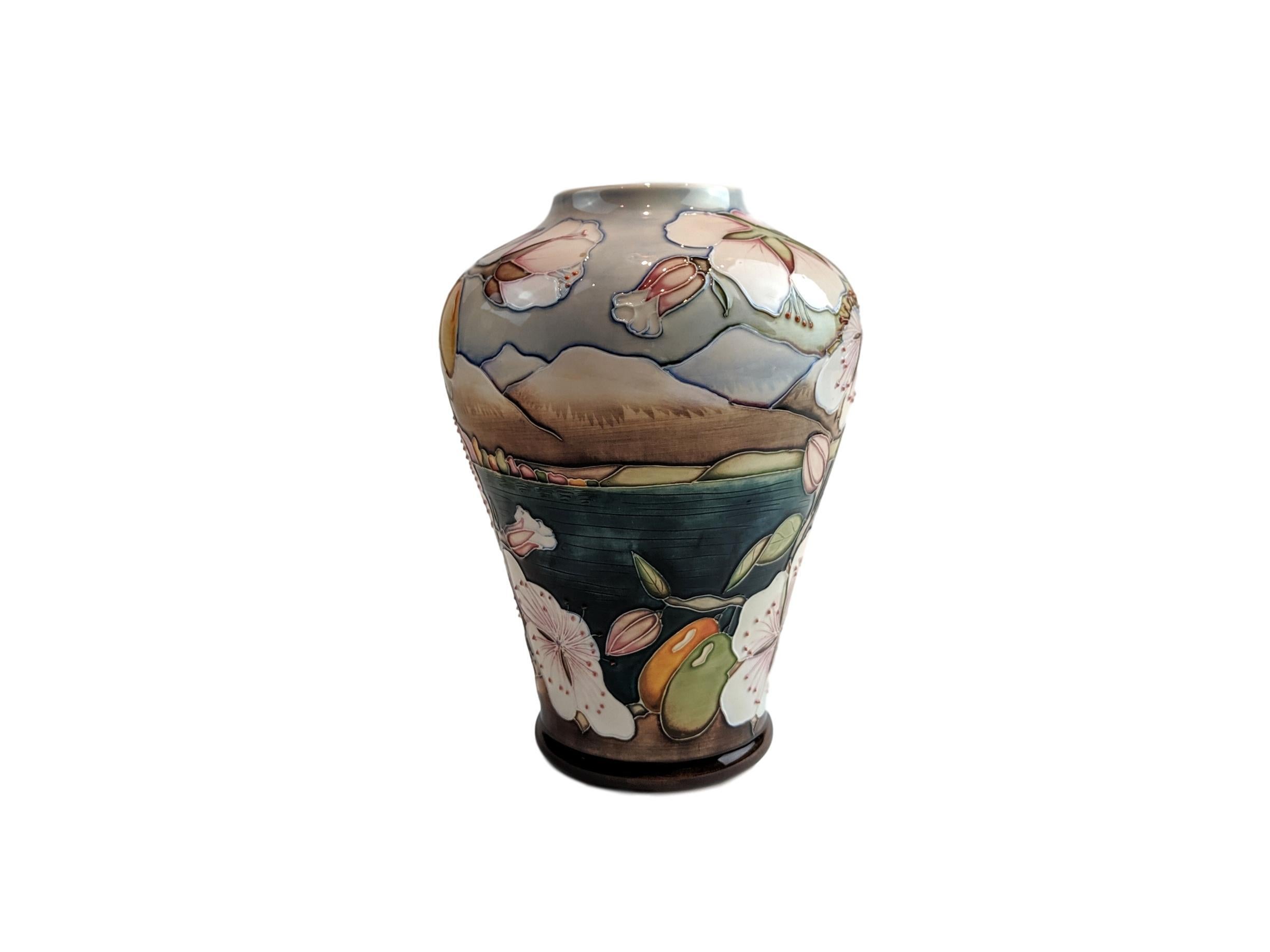 Moorcroft Limited Edition Elounda Vase by Alicia Amison, number 87 of 350. A vase on the 576/9 shape with beautiful colored cherry blossoms with ripening fruit on a lake scene measuring 9